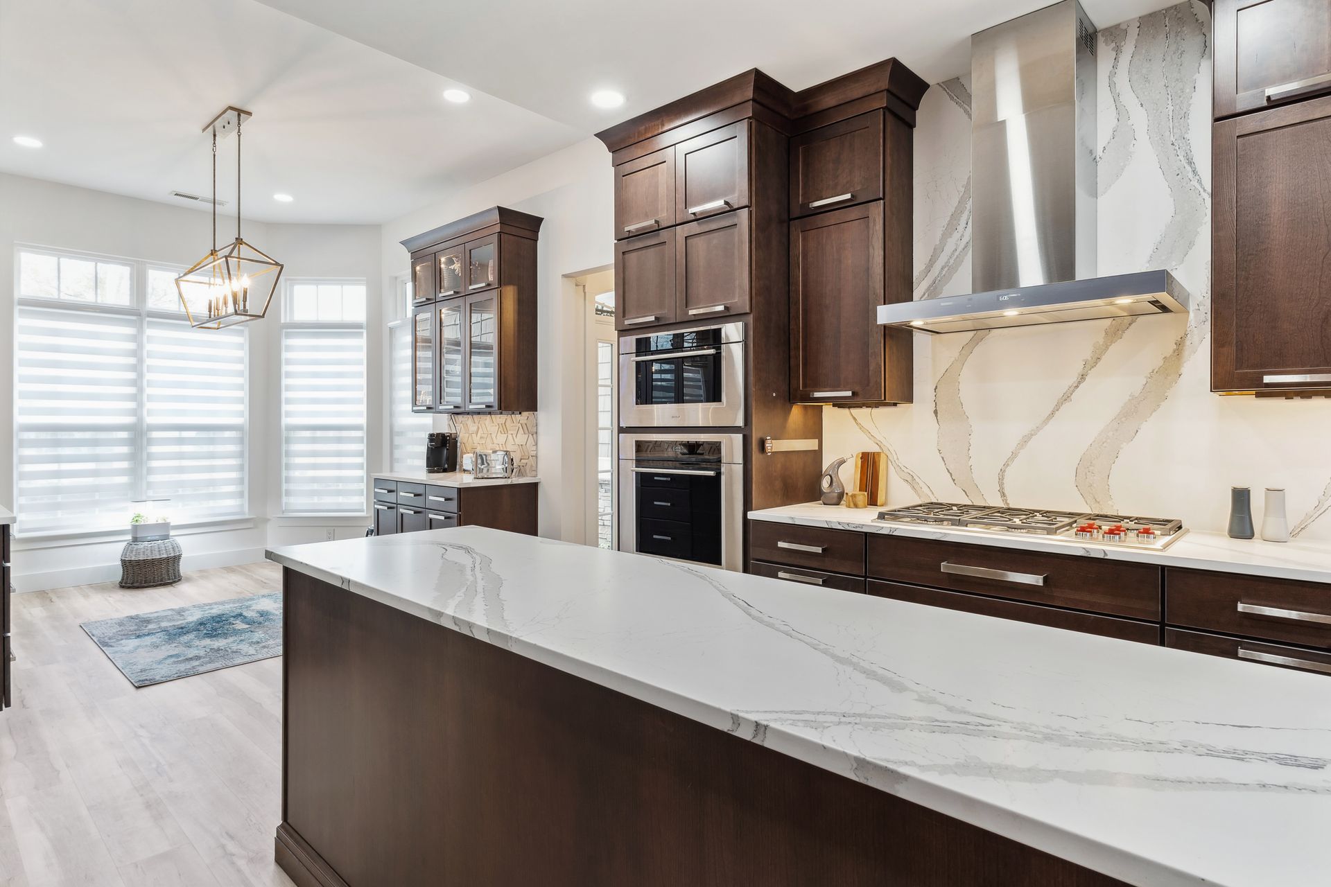 A kitchen with wooden cabinets and white counter tops.