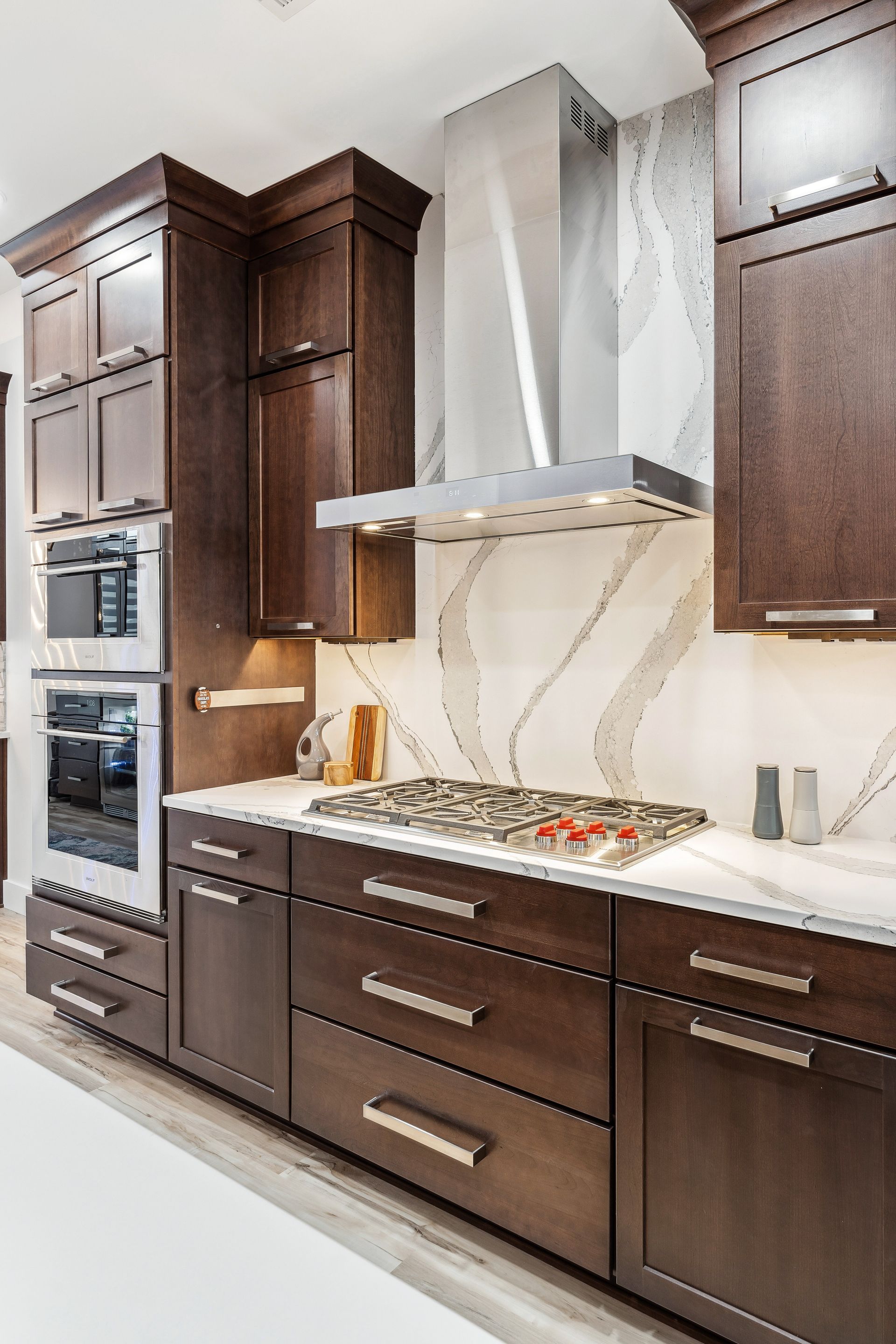 A kitchen with wooden cabinets, stainless steel appliances, and a stove top oven.