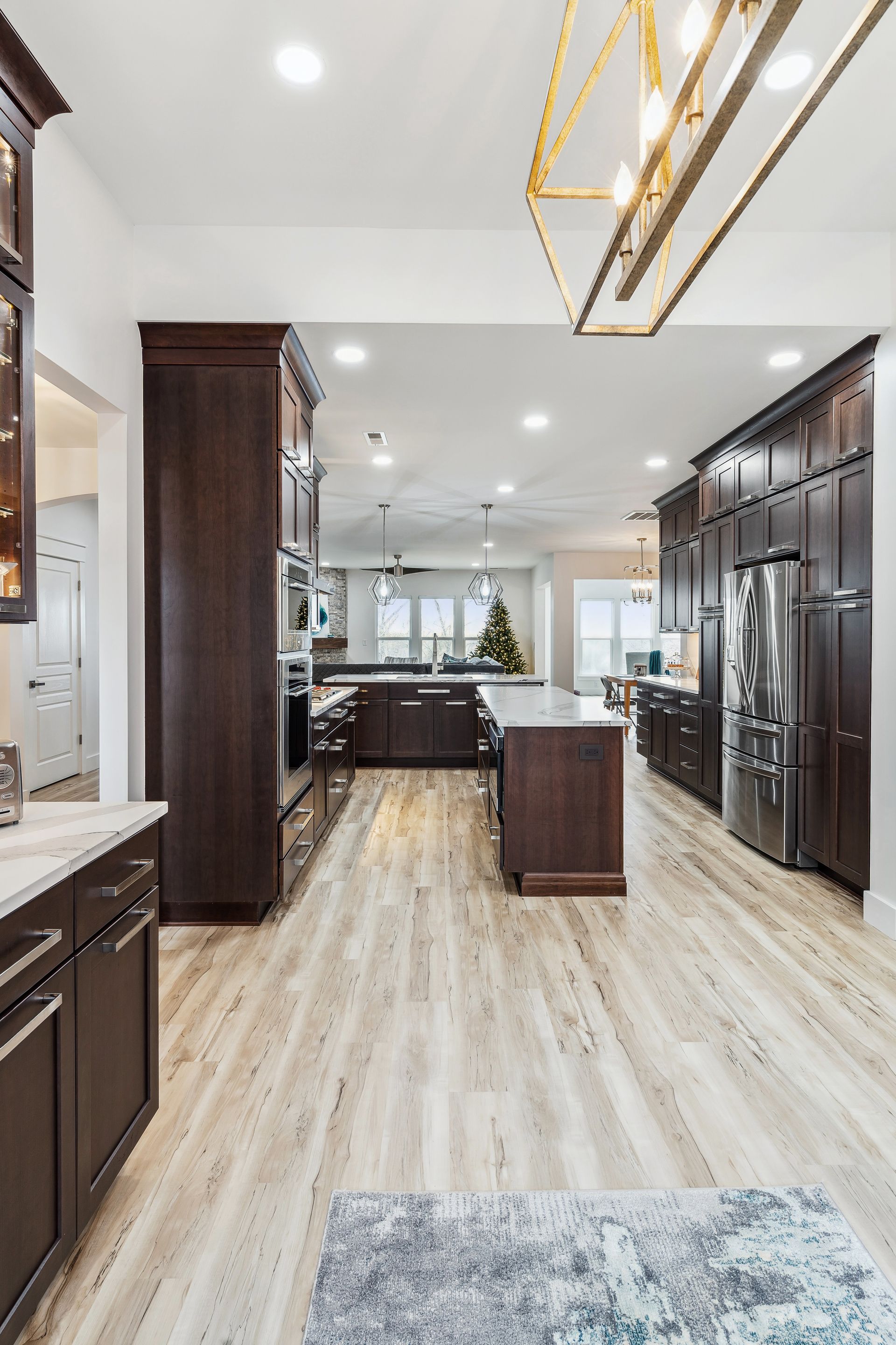 A kitchen with a lot of cabinets and hardwood floors.