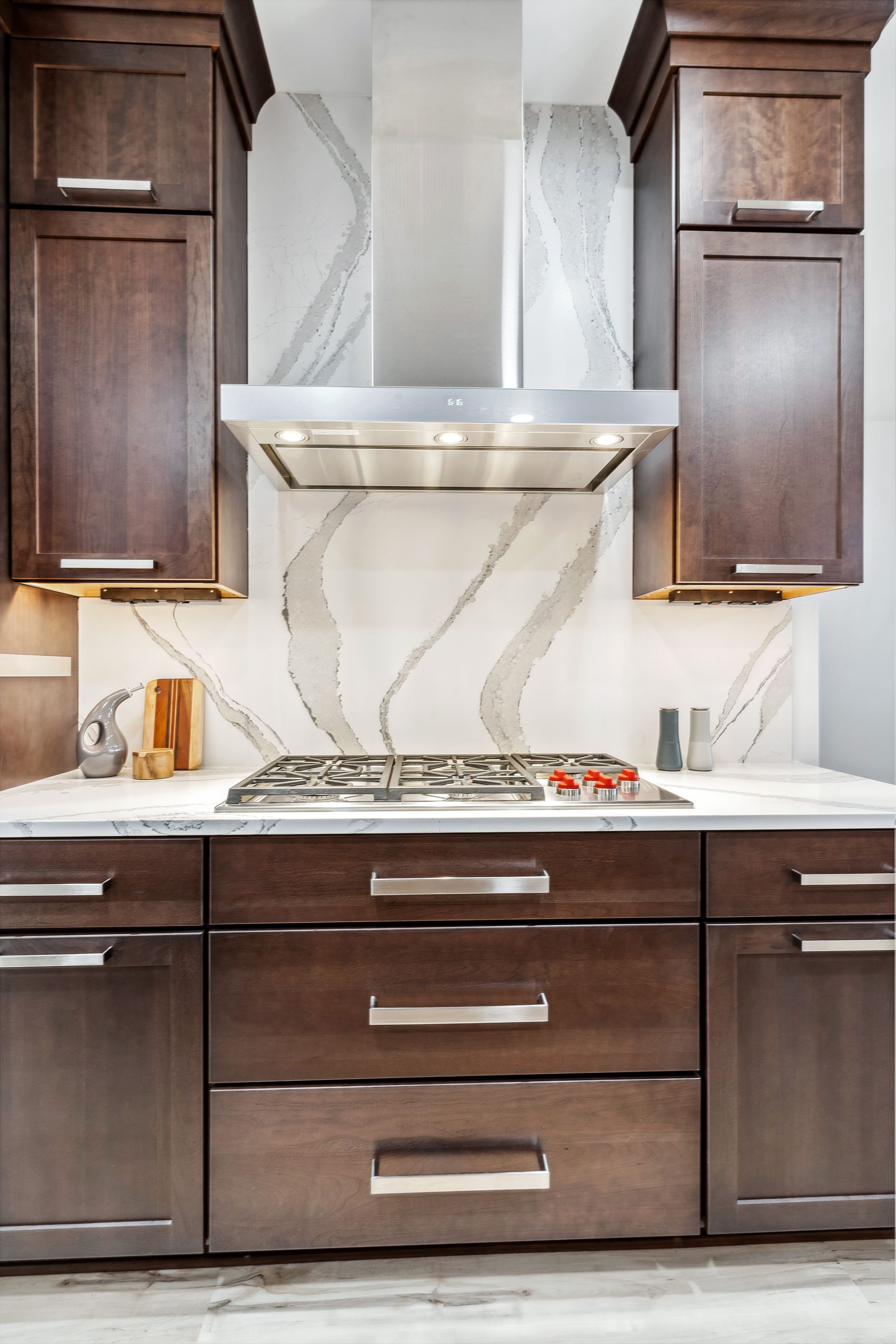 A kitchen with wooden cabinets and a stove top oven.