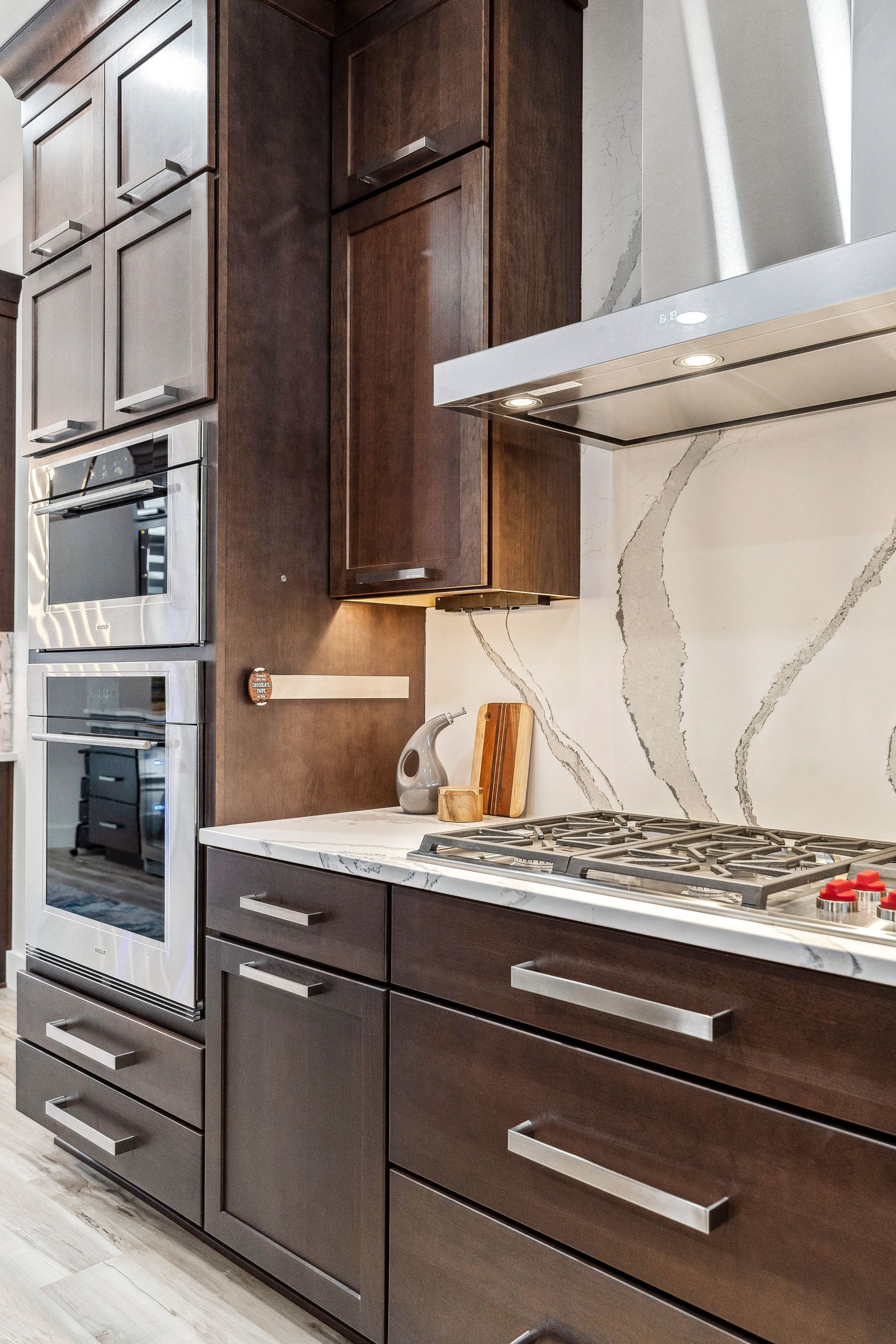 A kitchen with stainless steel appliances and wooden cabinets.