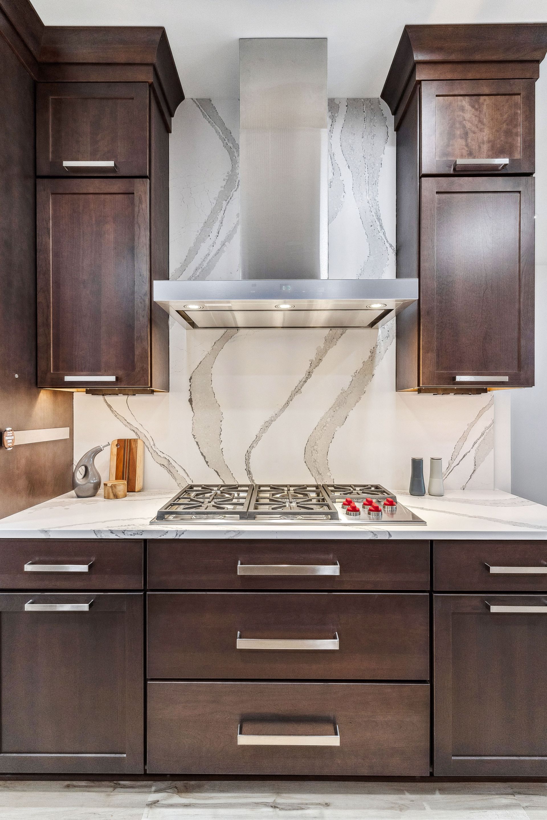 A kitchen with wooden cabinets and a stove top oven.