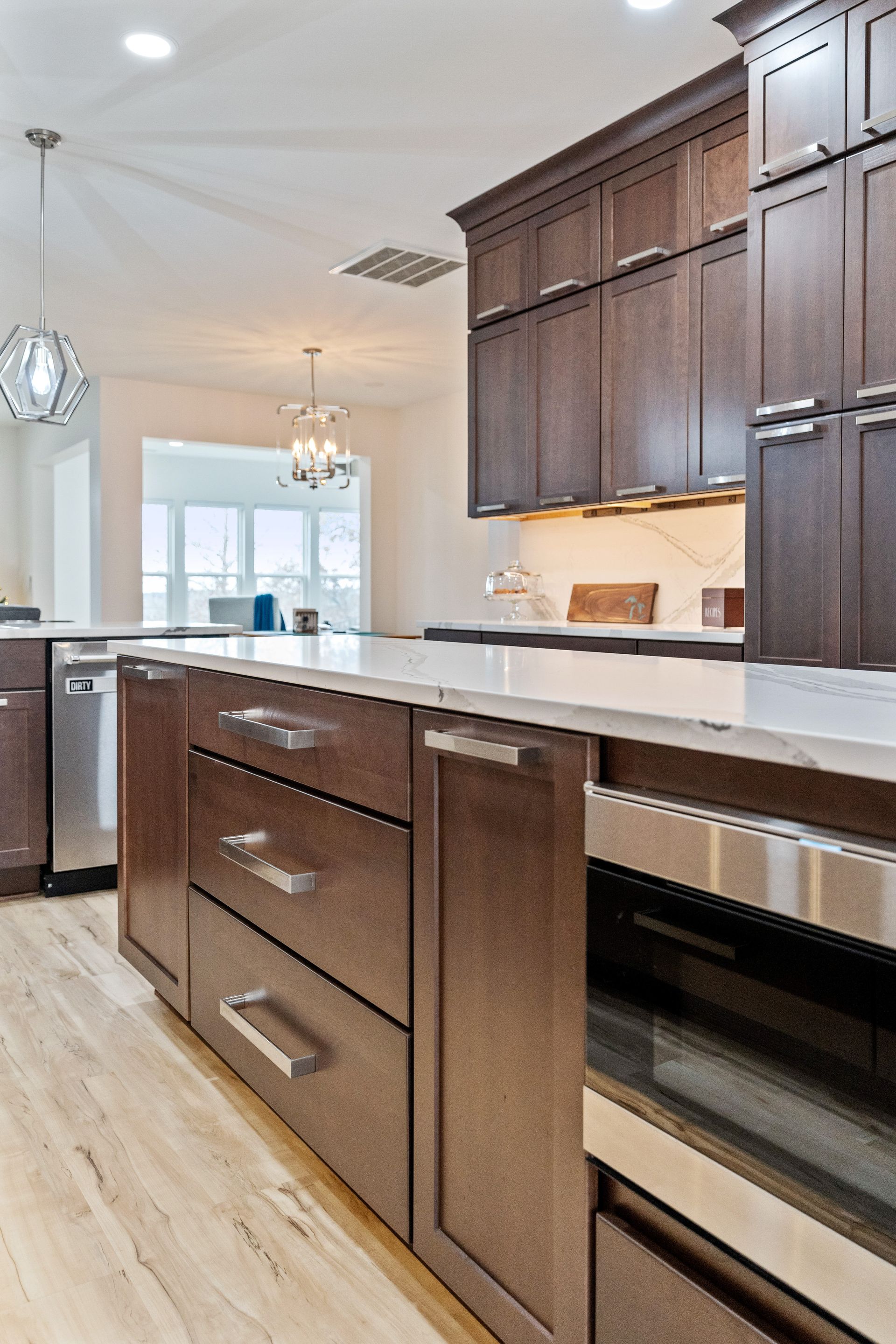 A kitchen with wooden cabinets and stainless steel appliances.