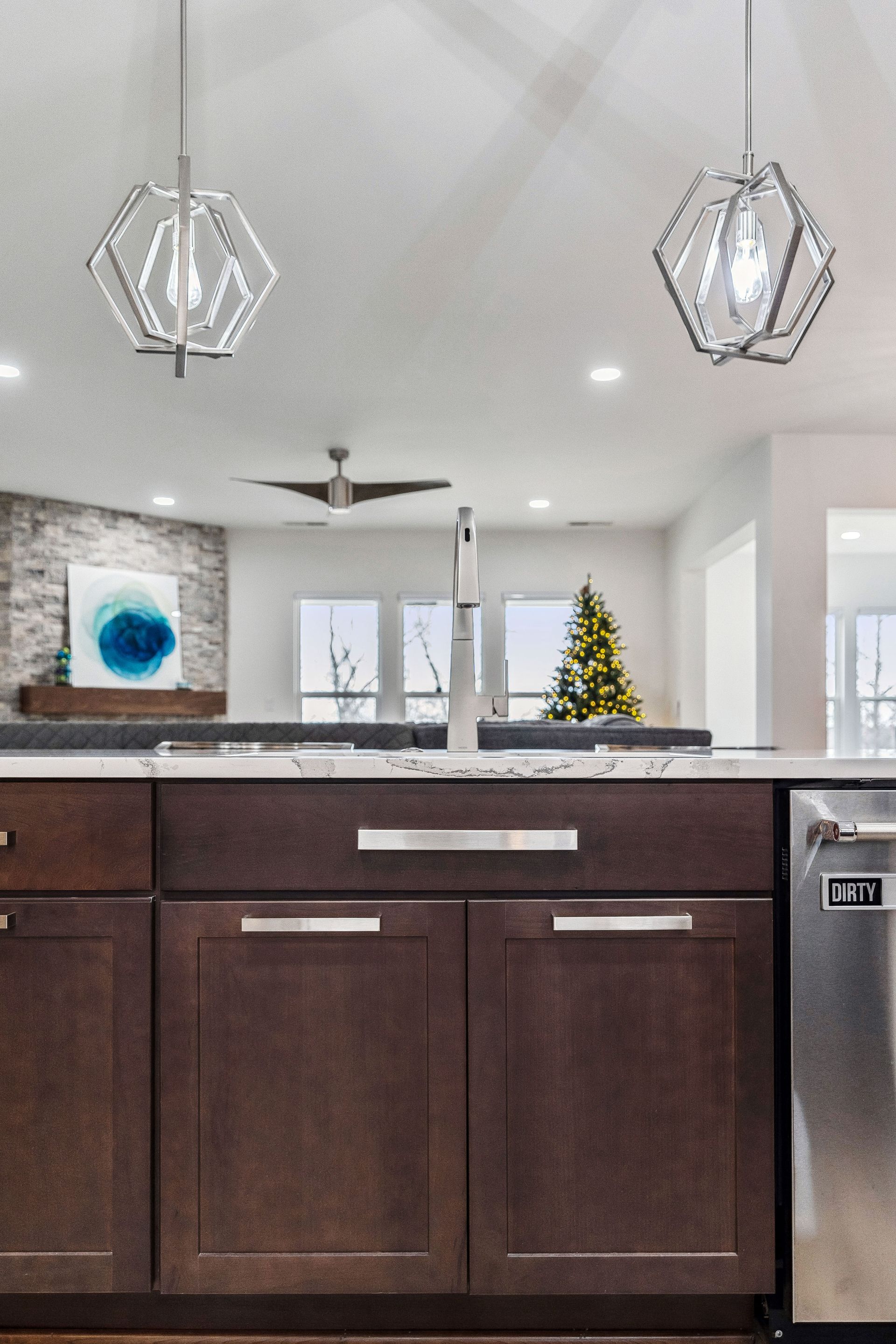 A kitchen with wooden cabinets and a stainless steel dishwasher