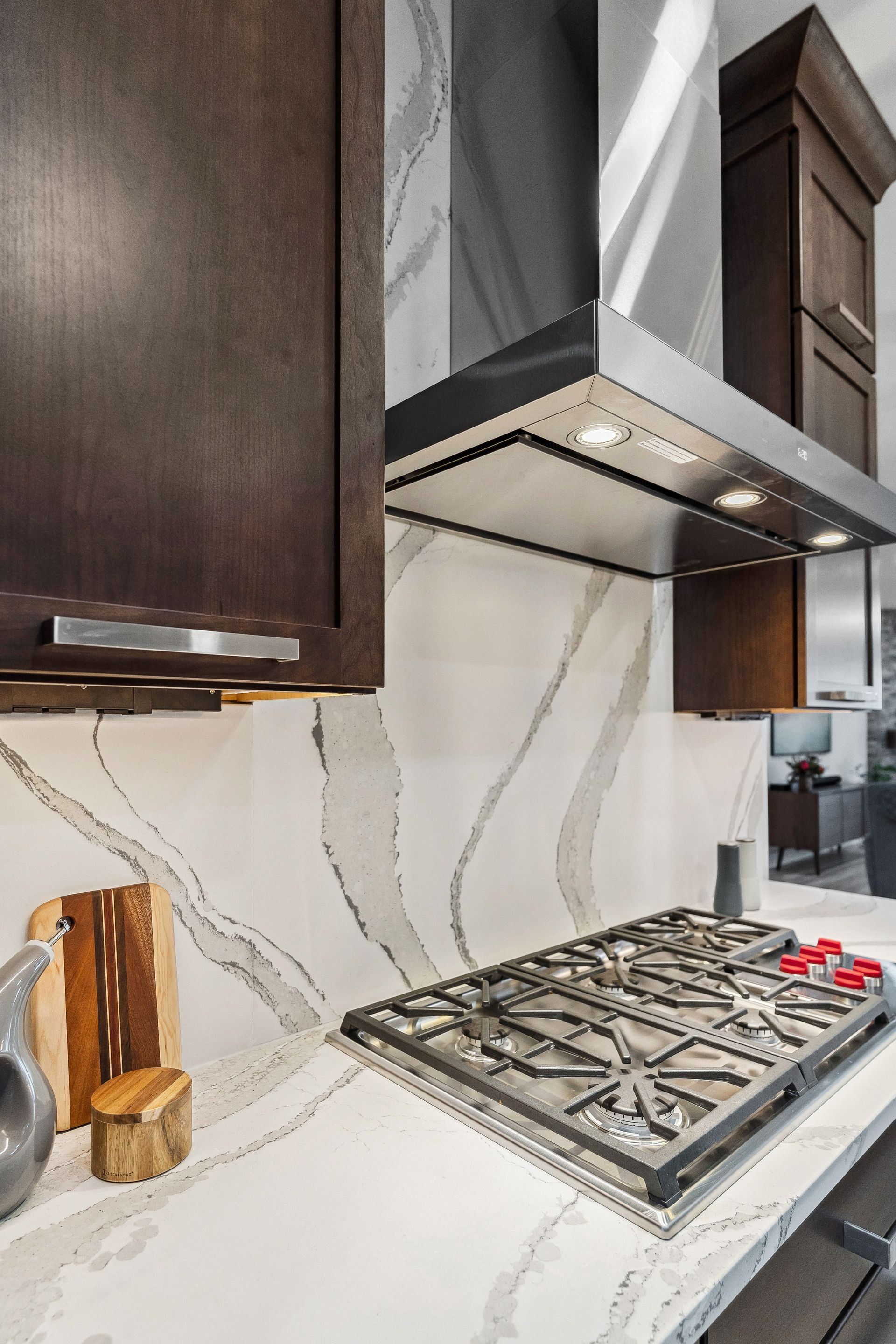 A kitchen with a stove top oven and a hood above it.