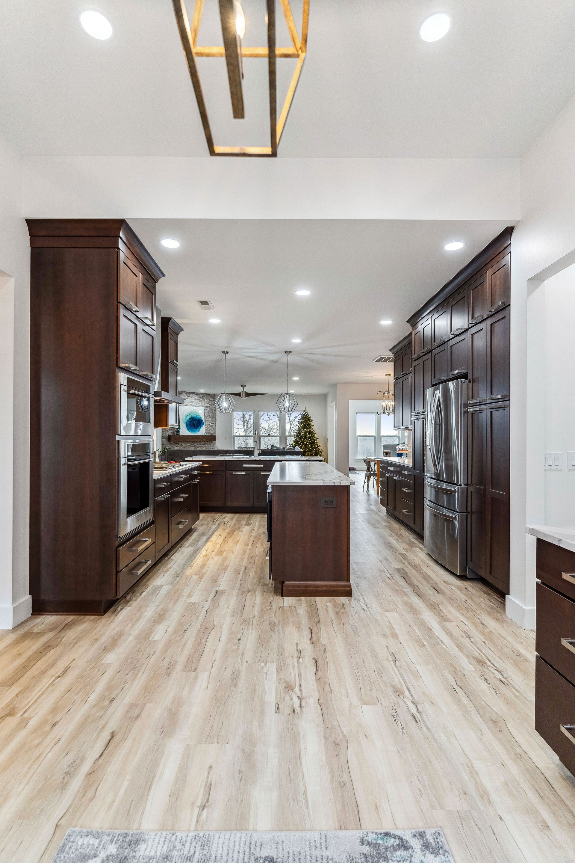 A kitchen with wooden floors and stainless steel appliances.