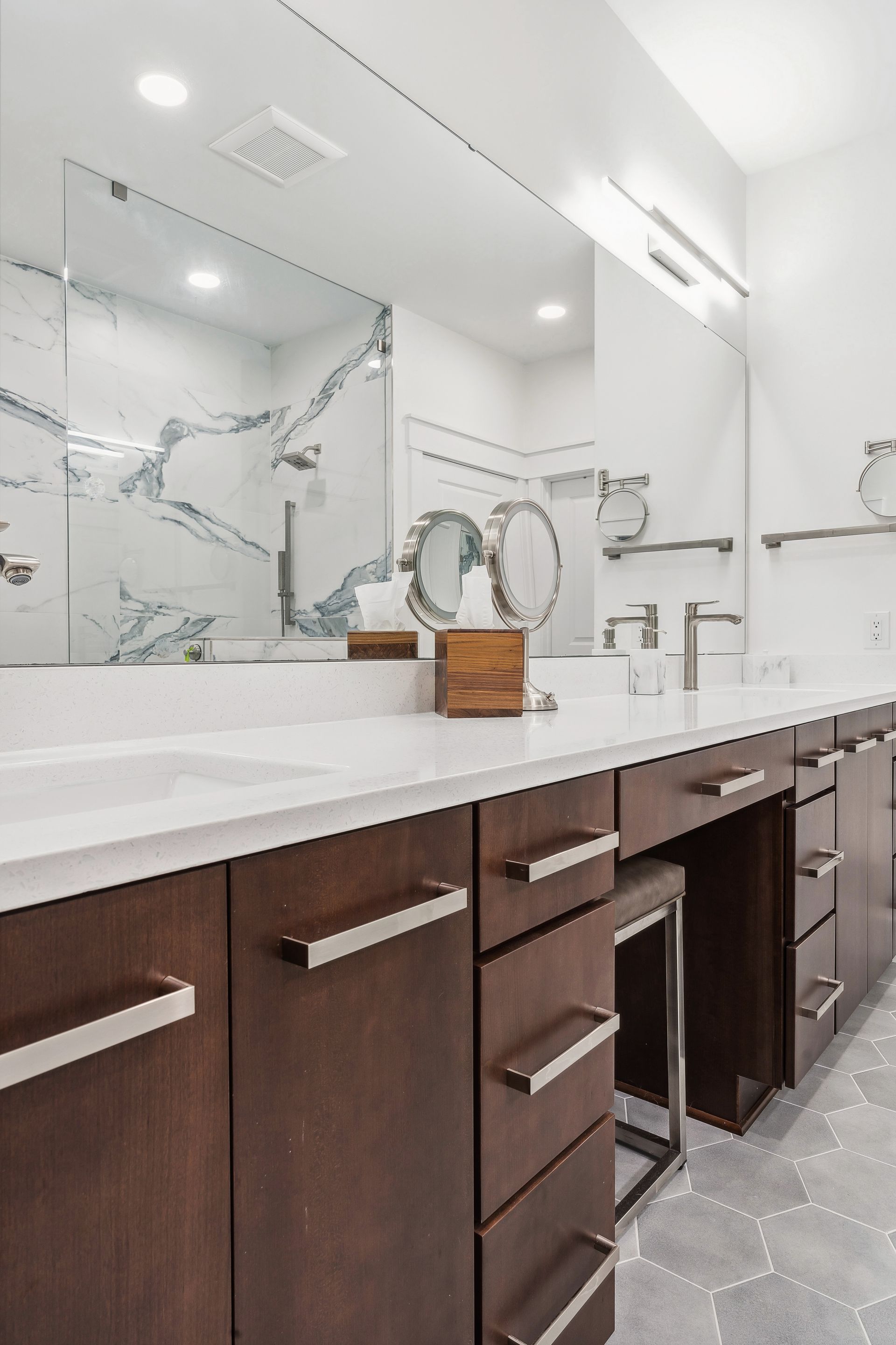 A bathroom with two sinks and a large mirror.