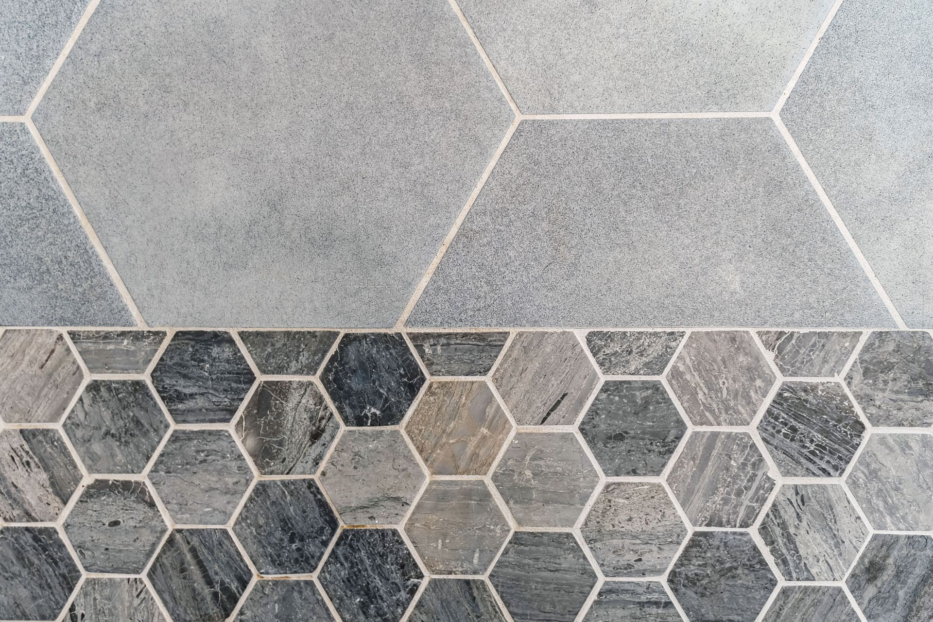 A close up of a tile floor with a hexagon pattern.