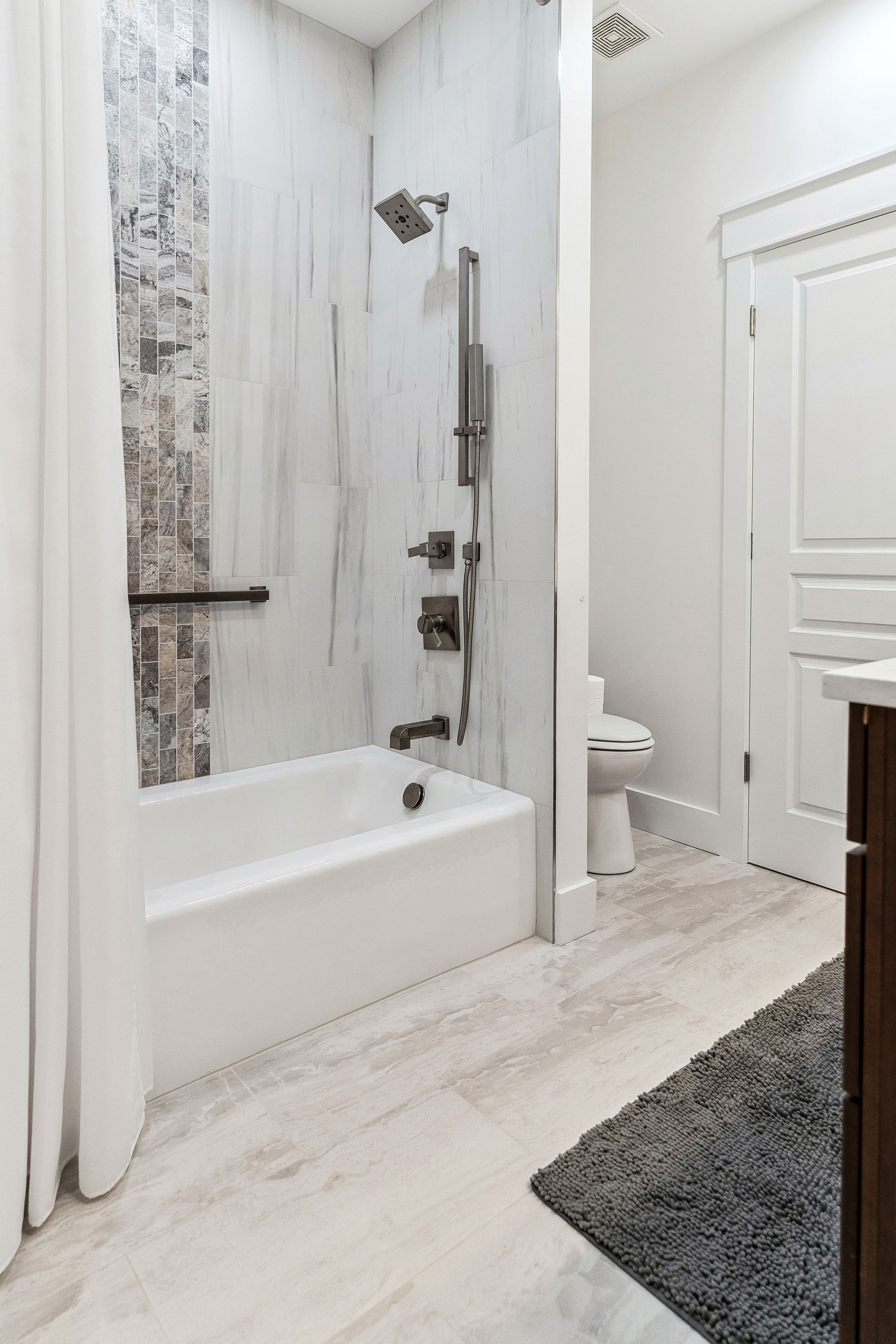 A bathroom with a bathtub, toilet and shower.