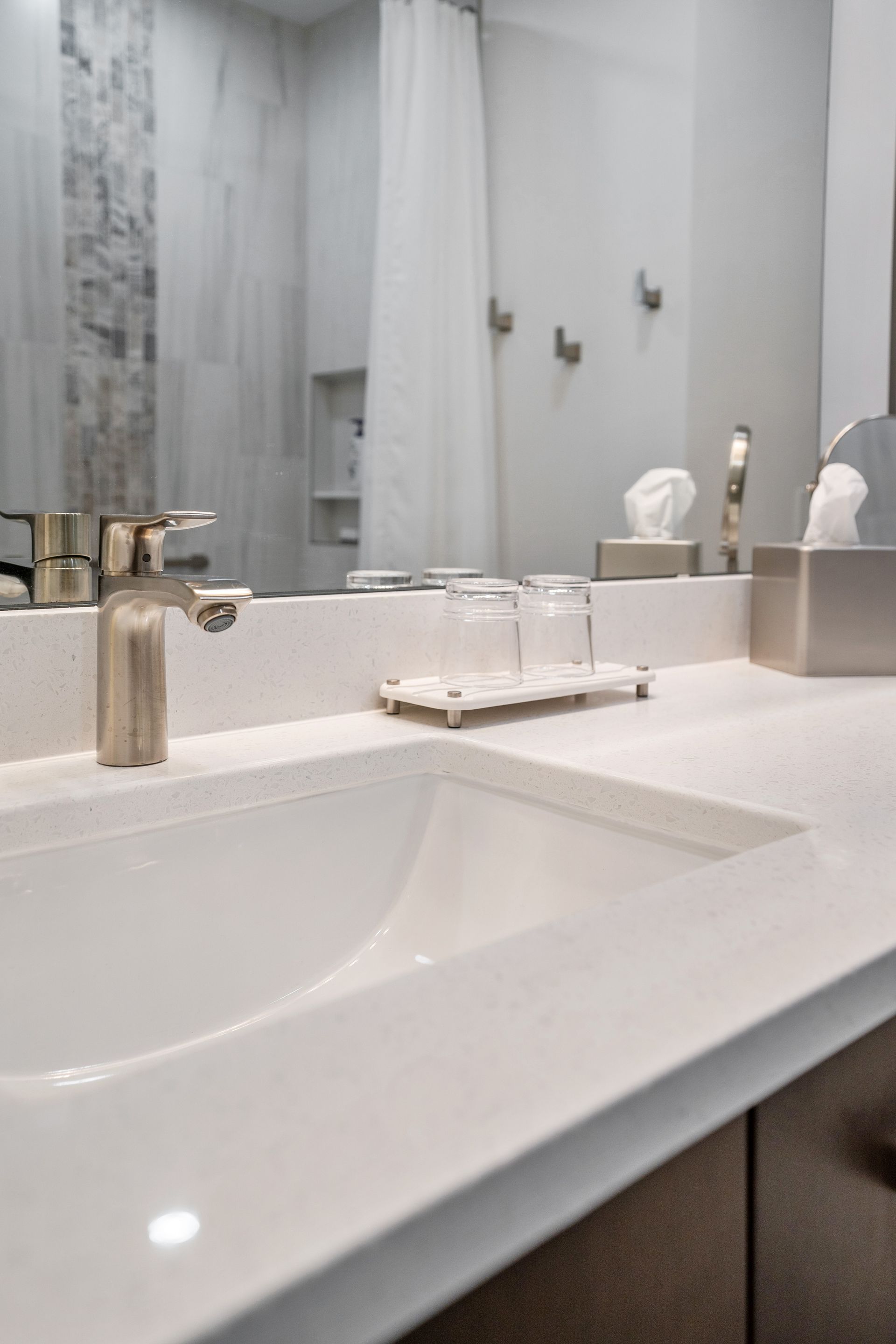 A bathroom sink with a faucet and a mirror.