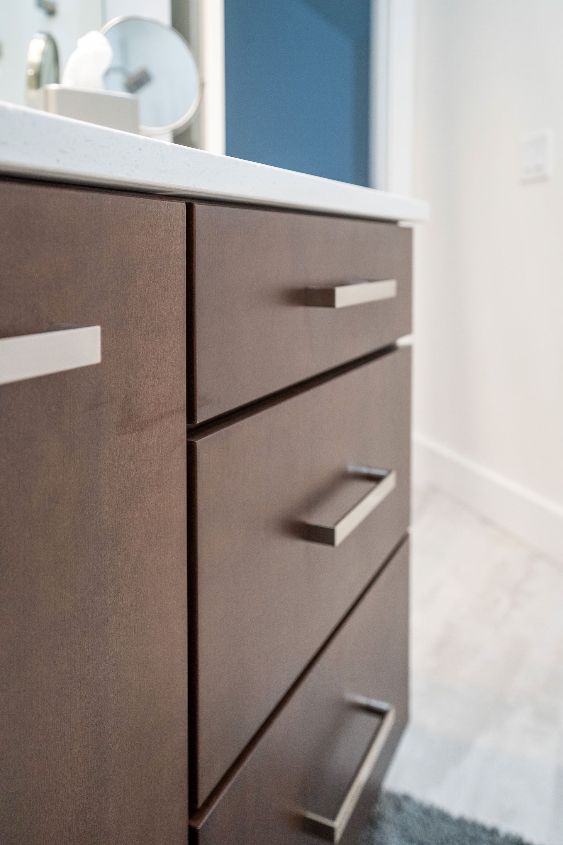 A bathroom vanity with three drawers and a sink