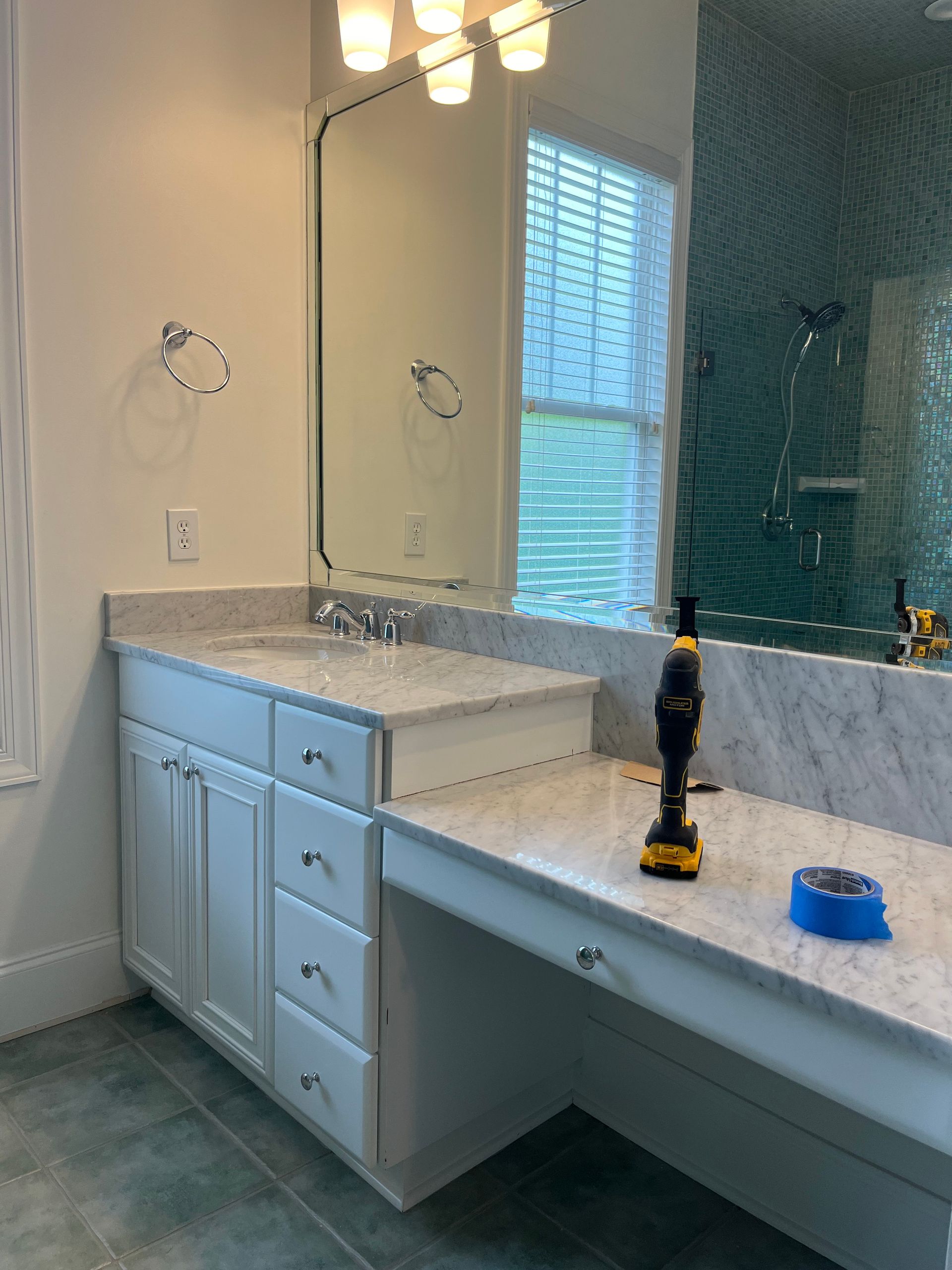 A bathroom with two sinks and a large mirror.