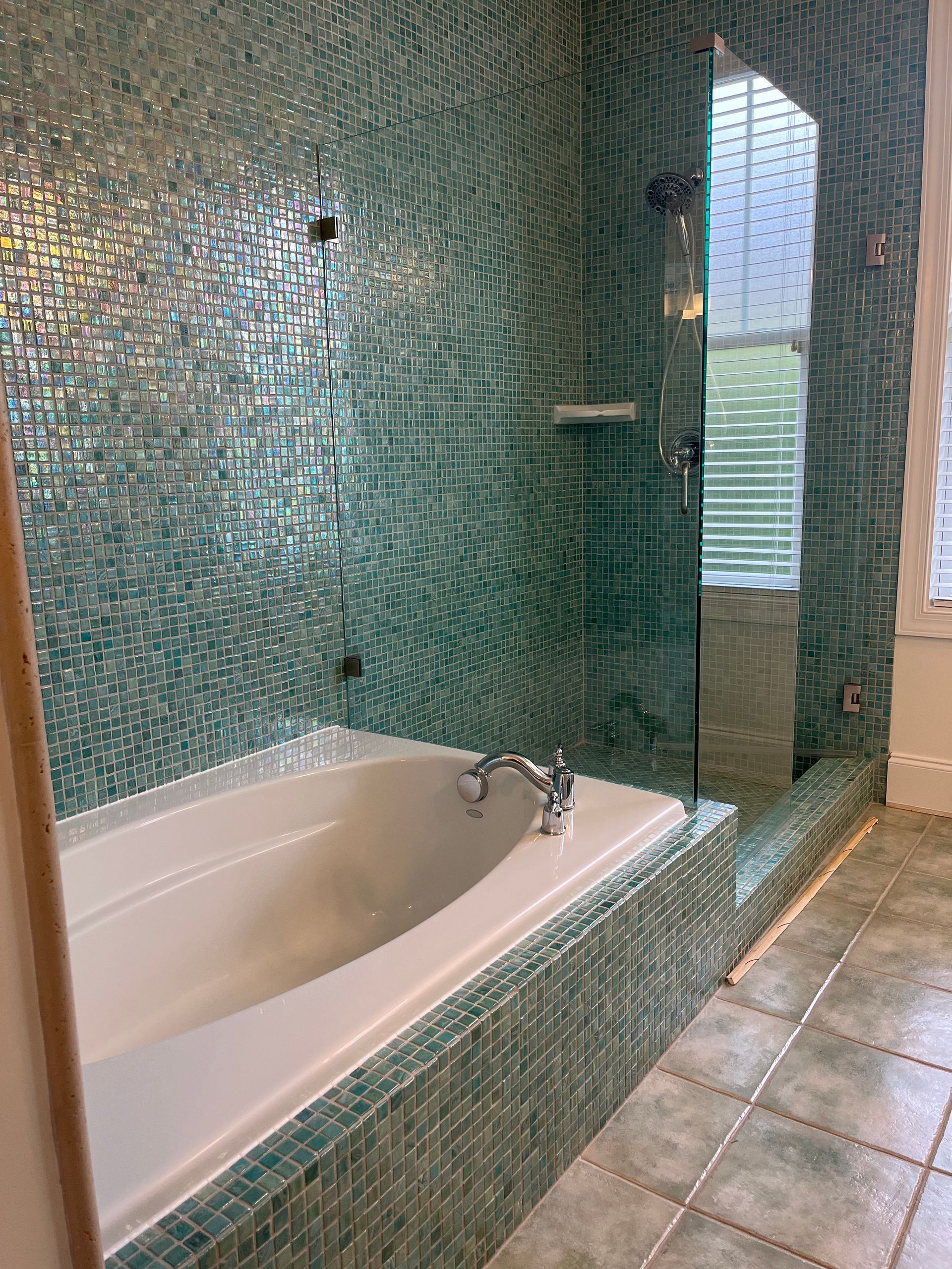 A bathroom with a bathtub and a shower.