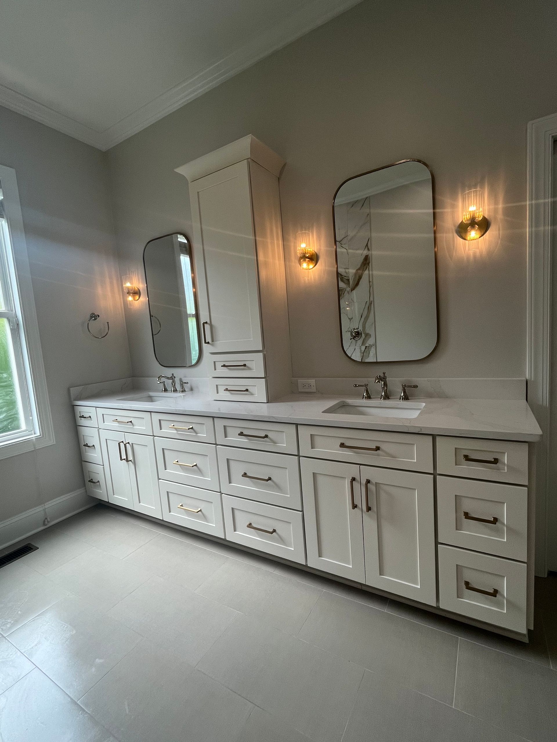 A bathroom with two sinks and two mirrors.