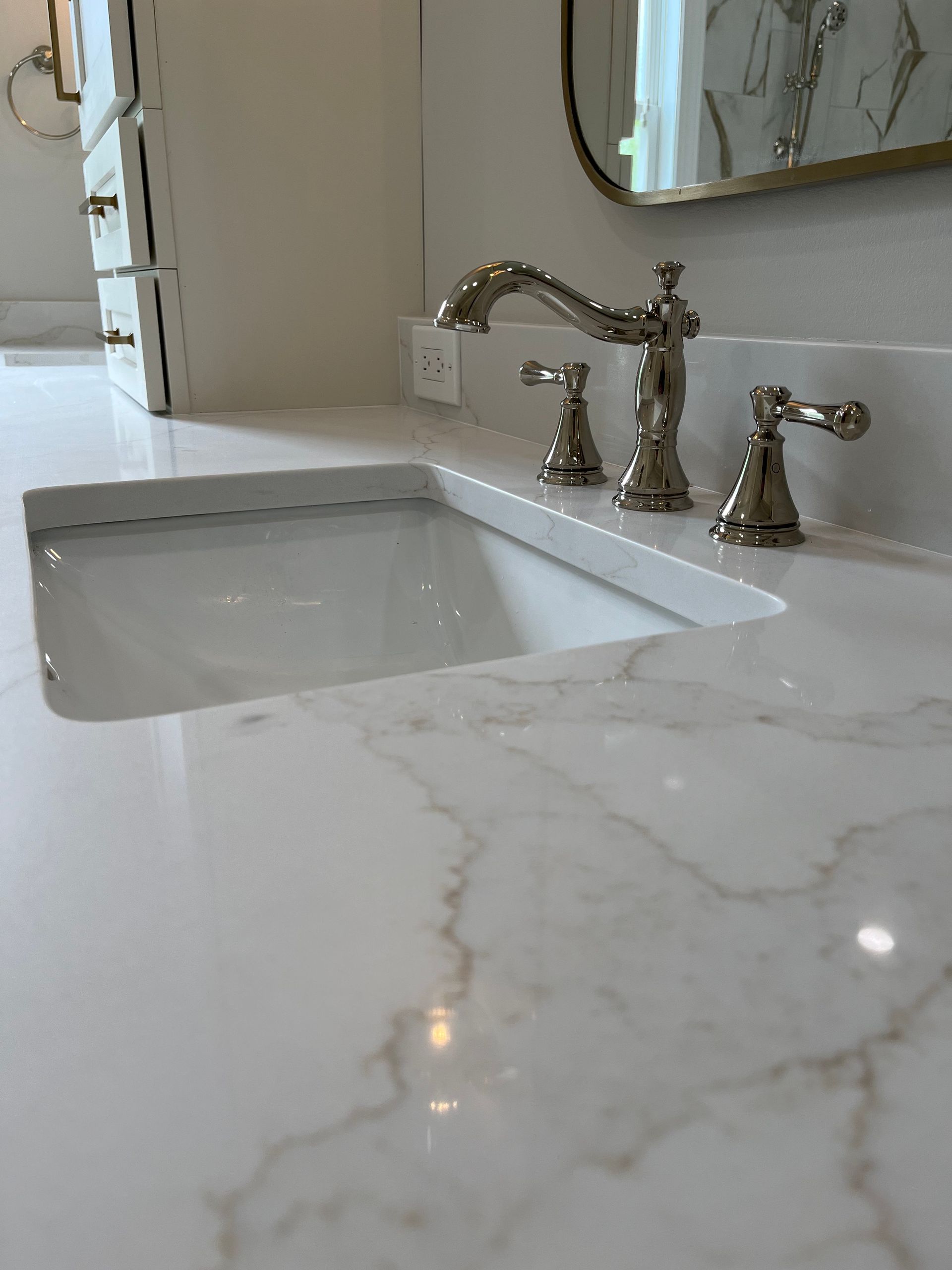A bathroom sink with a faucet and a mirror