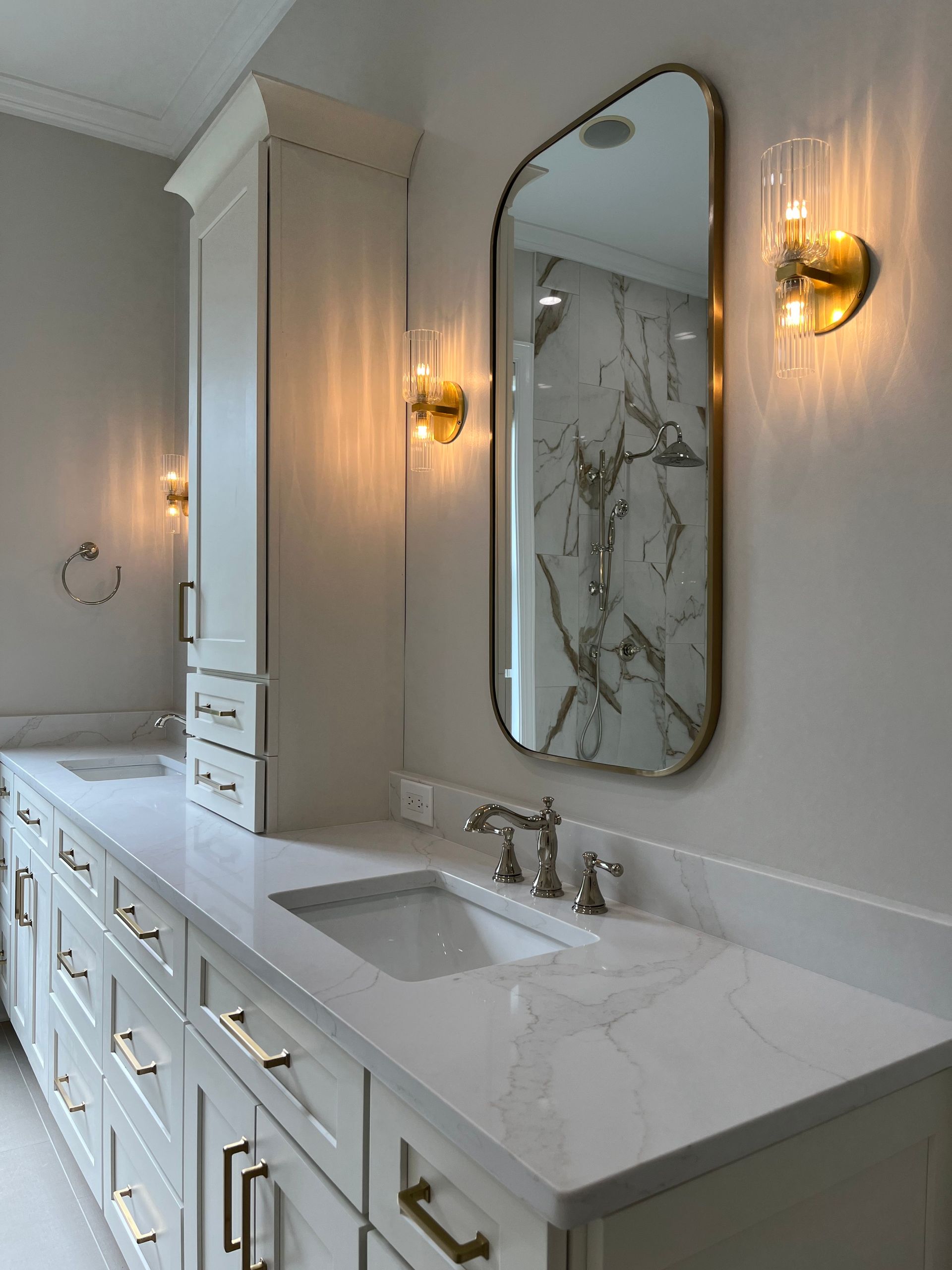 A bathroom with two sinks and a large mirror.