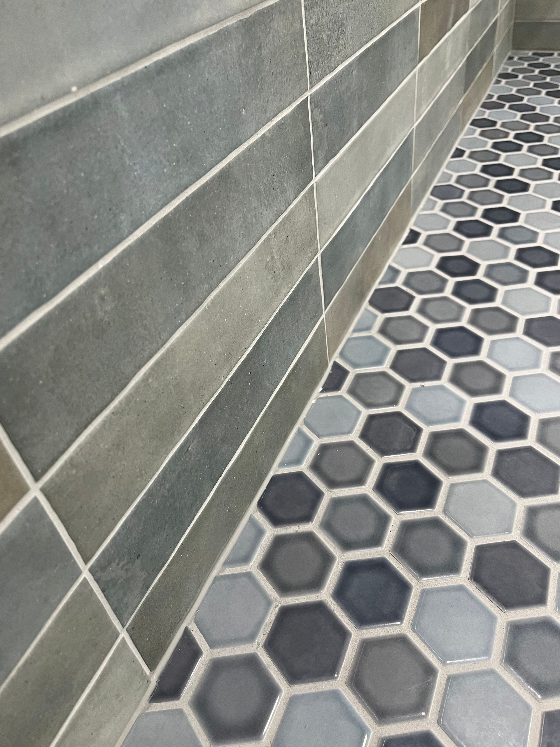 A close up of a tile floor with a honeycomb pattern