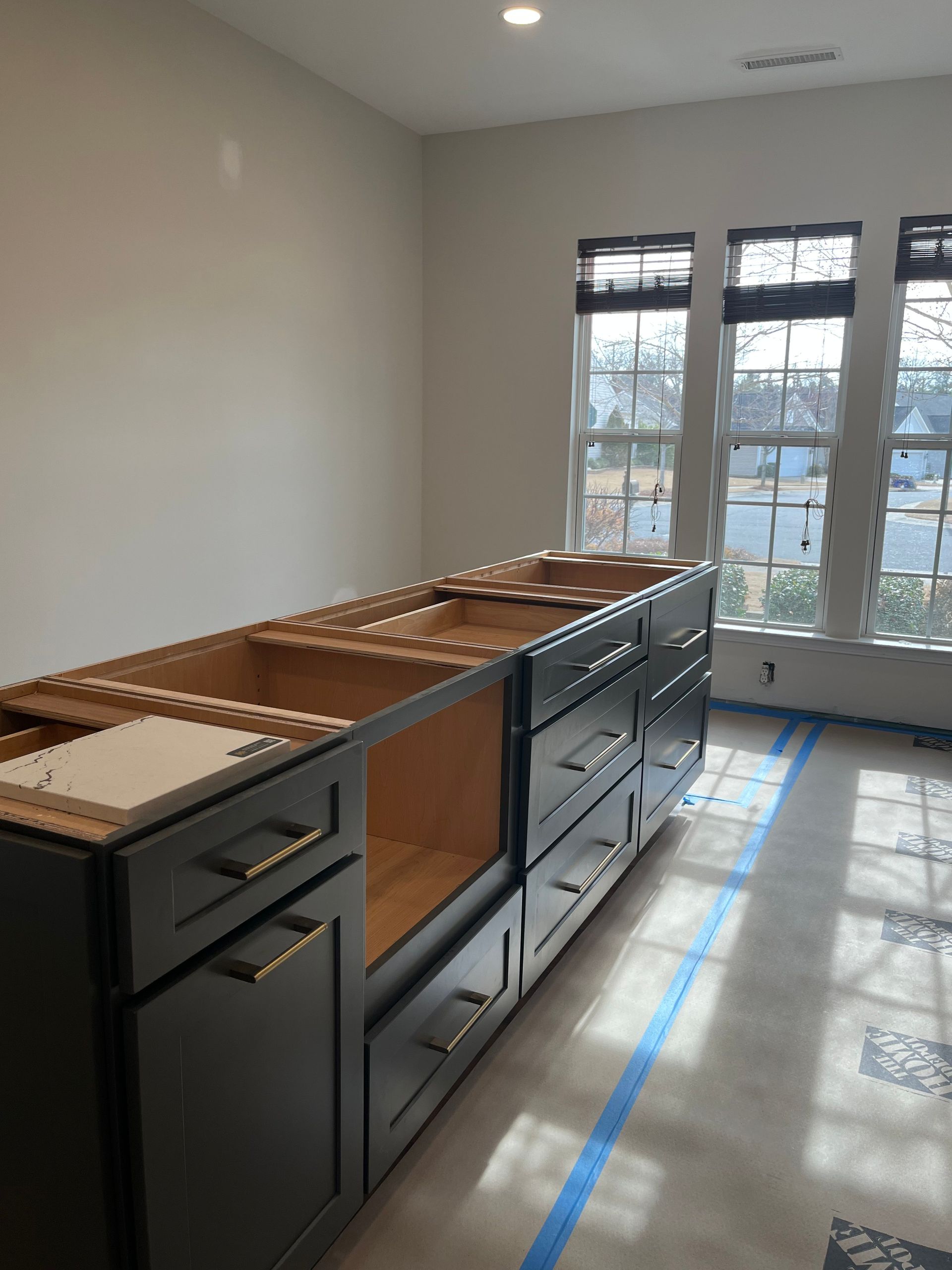 A kitchen with a lot of cabinets and drawers