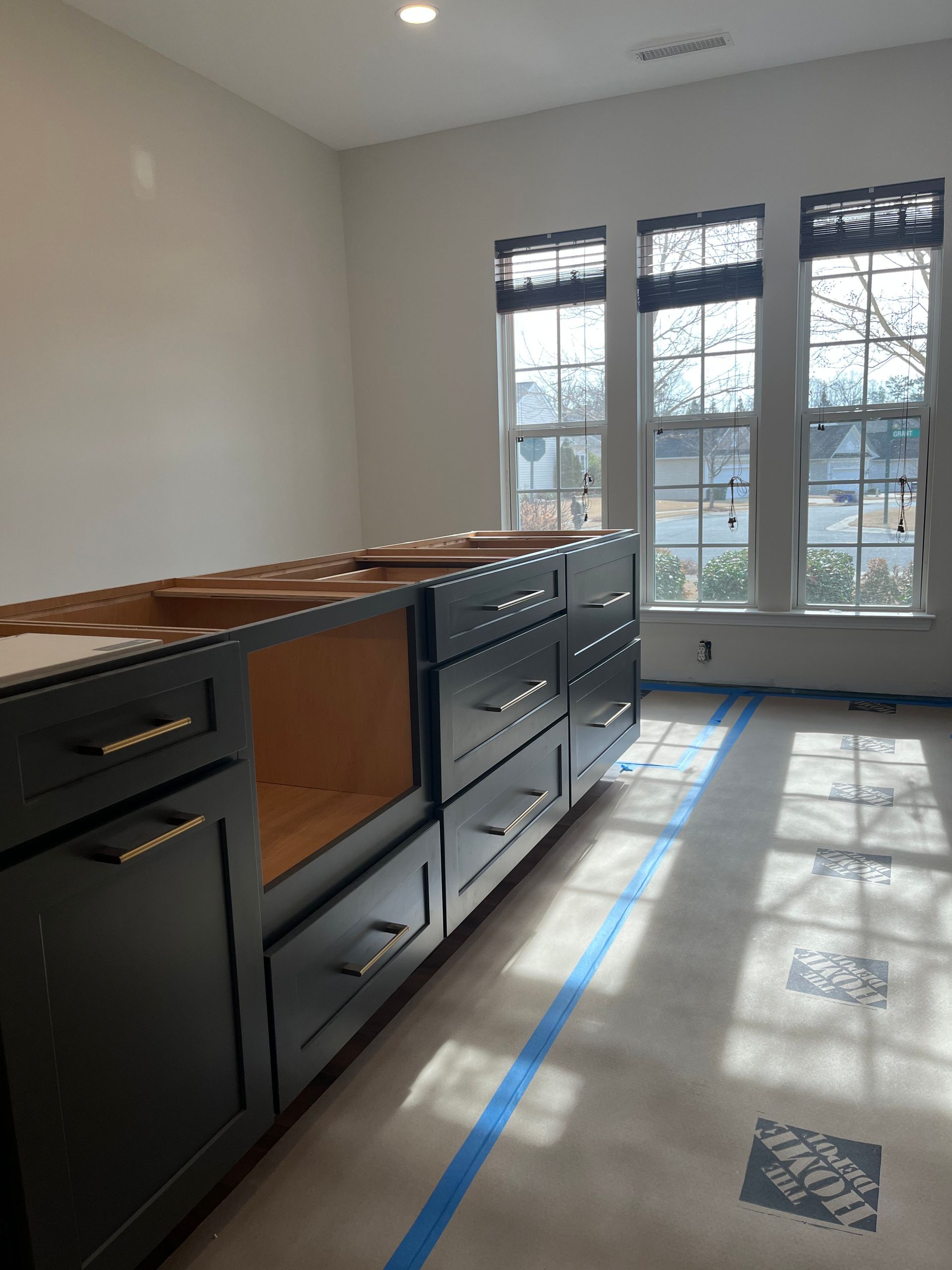 A kitchen under construction with the home depot tape on the floor