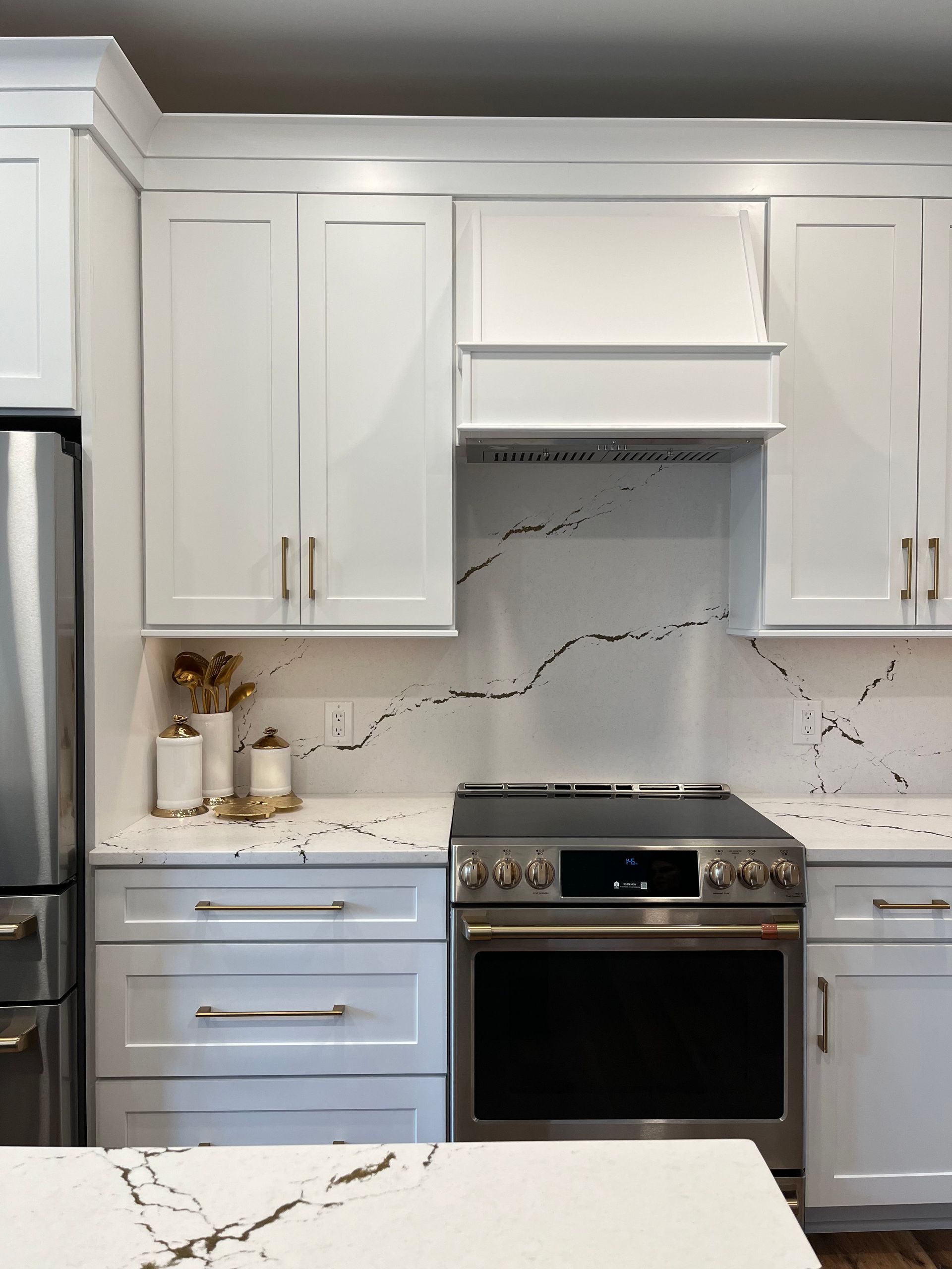 A kitchen with white cabinets and stainless steel appliances