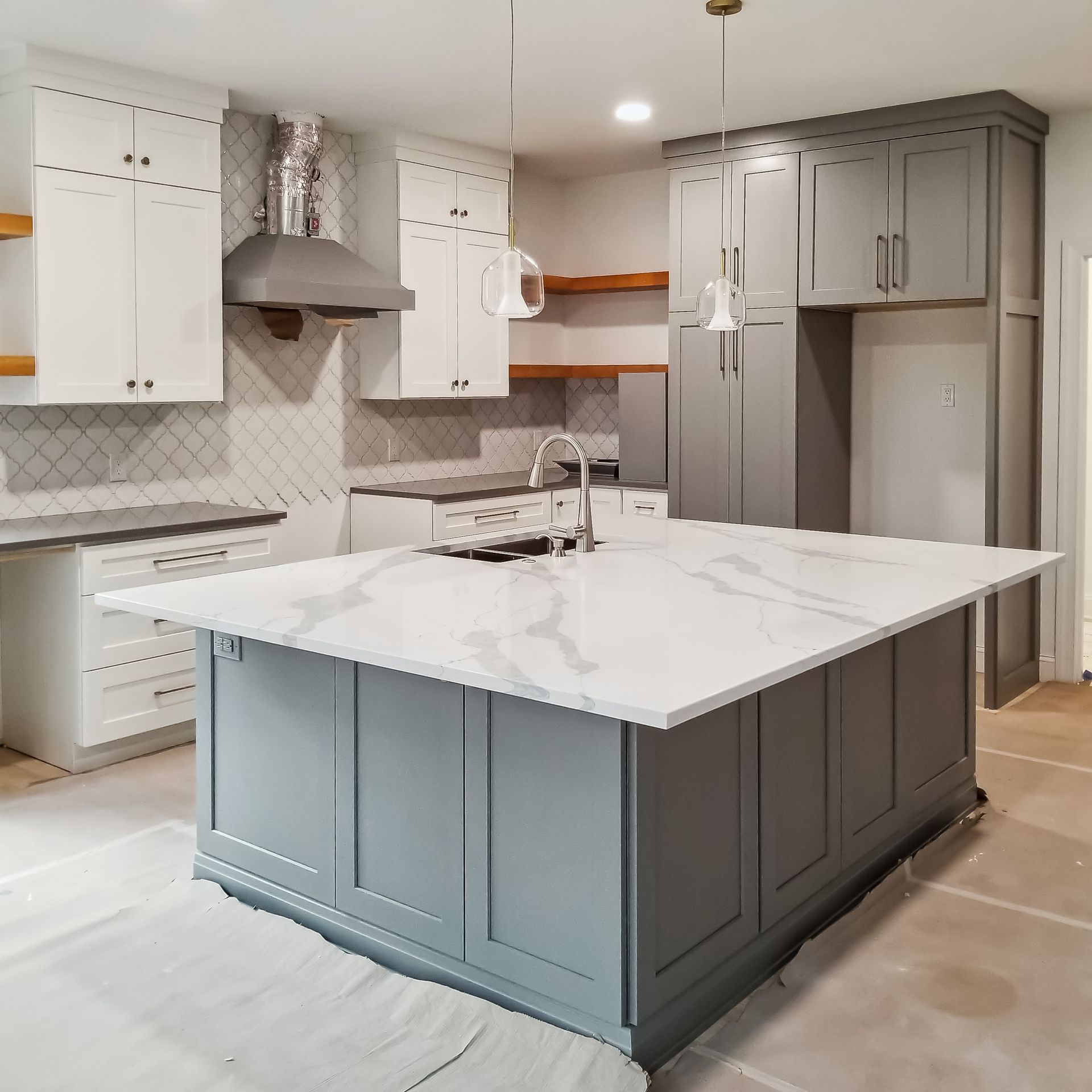 A kitchen with a large island in the middle
