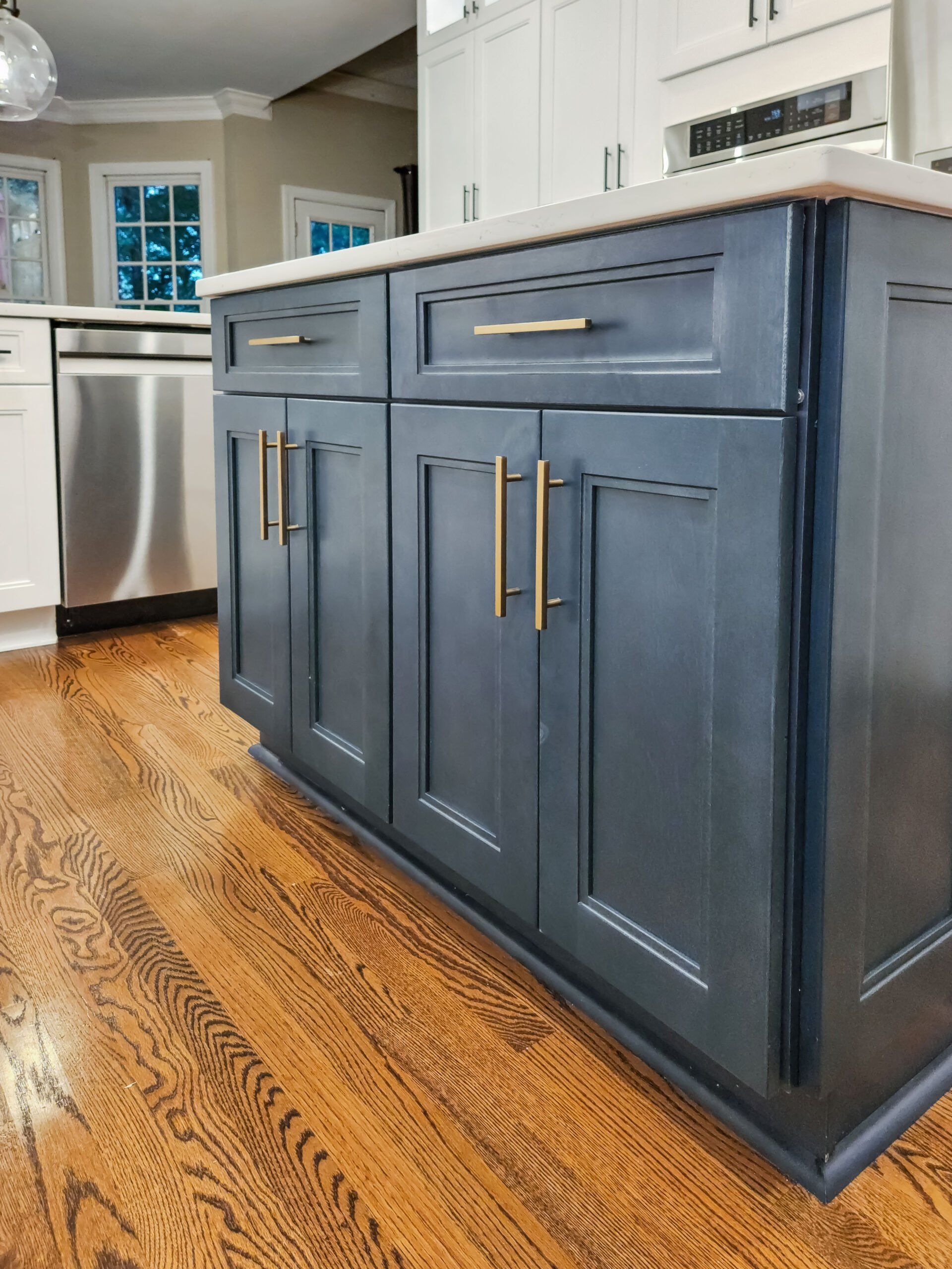 A kitchen with blue cabinets and stainless steel appliances