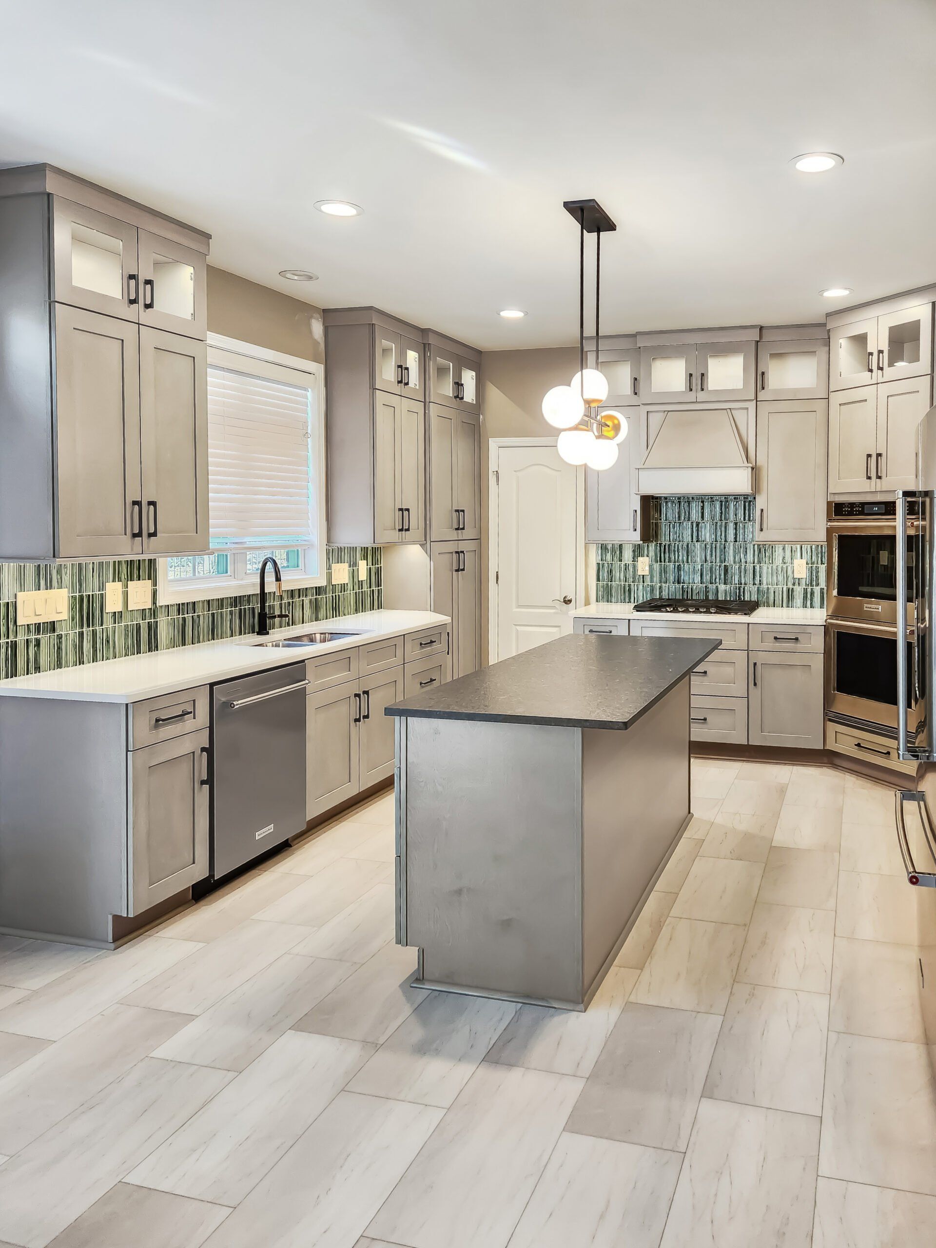 A kitchen with a large island and stainless steel appliances