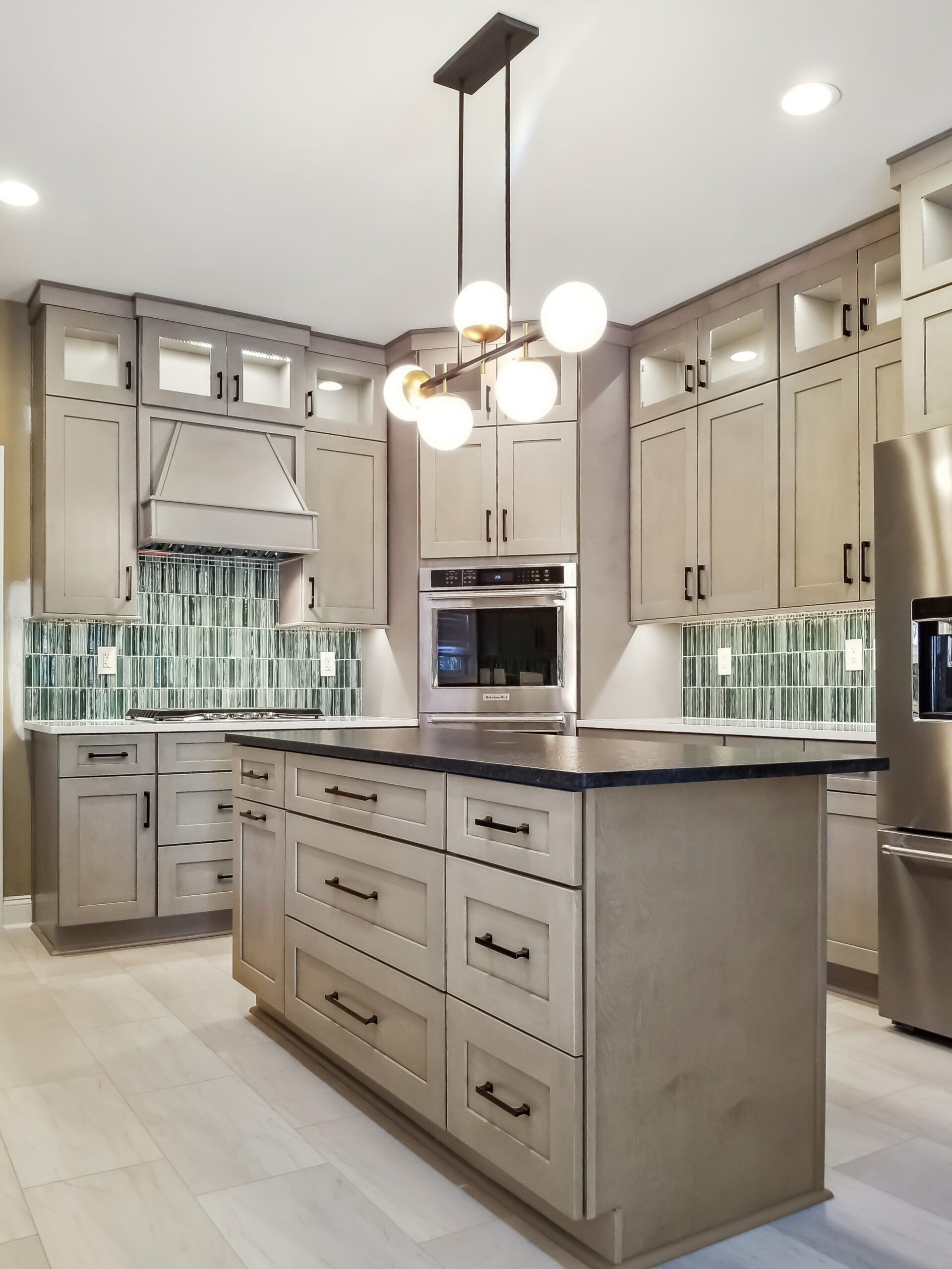 A kitchen with stainless steel appliances and a large island