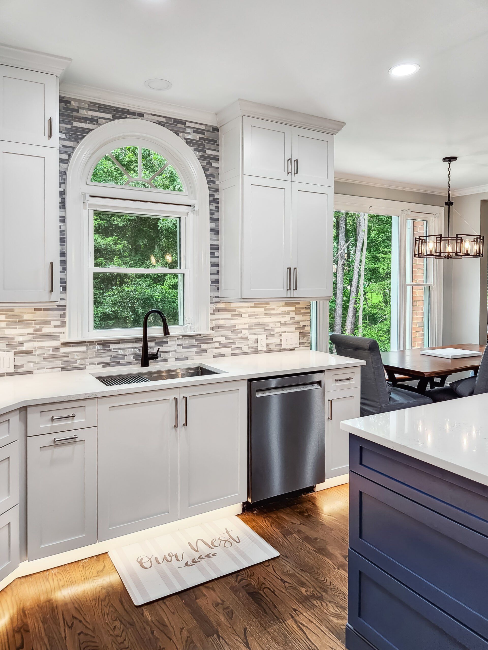 A kitchen with white cabinets and stainless steel appliances