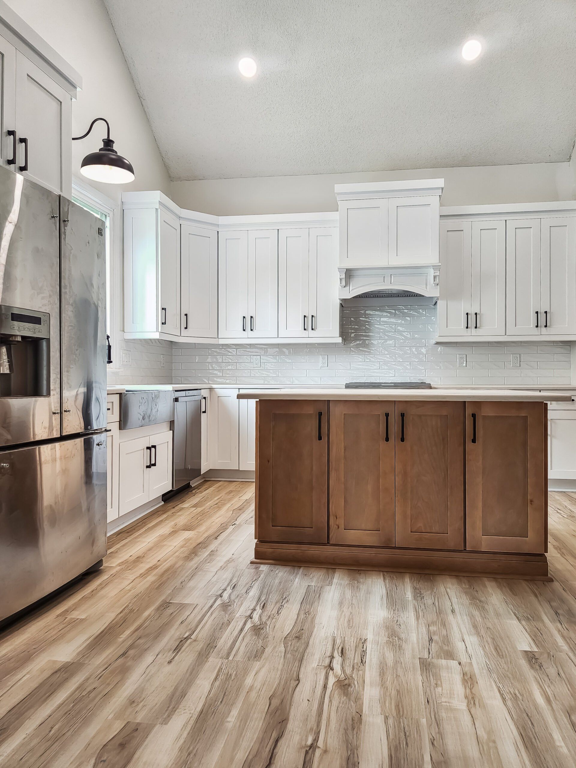 A kitchen with stainless steel appliances and wooden cabinets