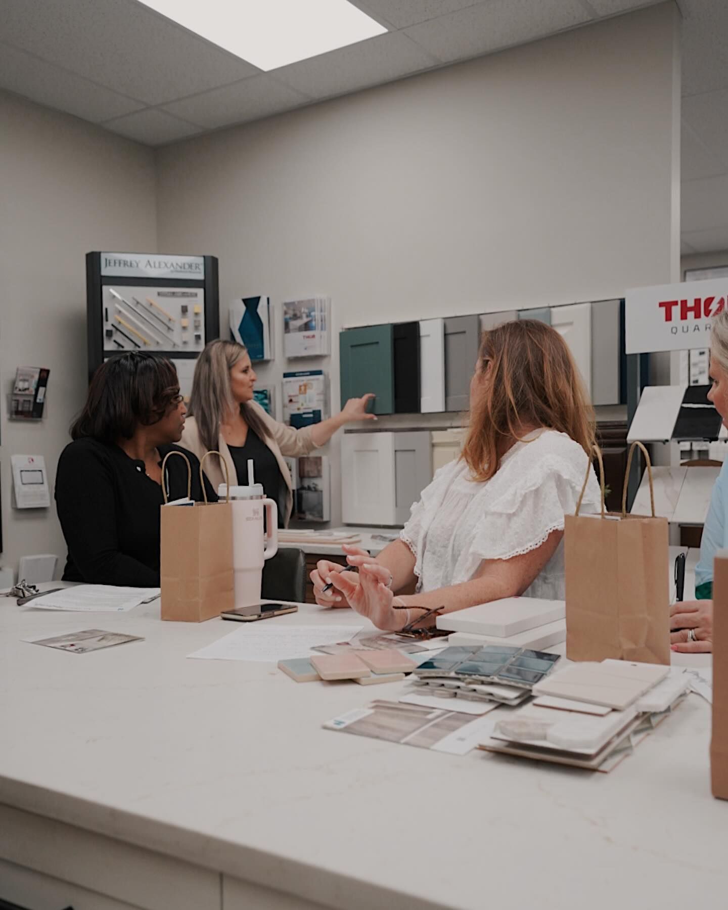 A group of women are sitting at a table in a room.