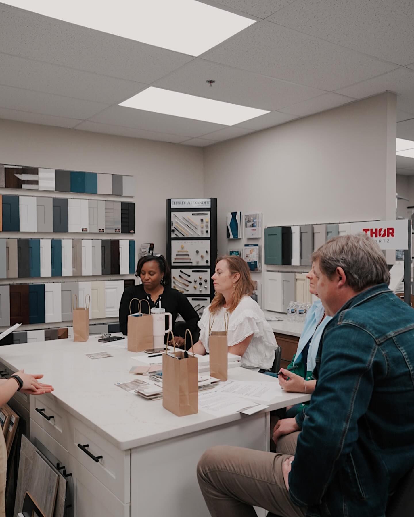 A group of people are sitting around a table in a room.