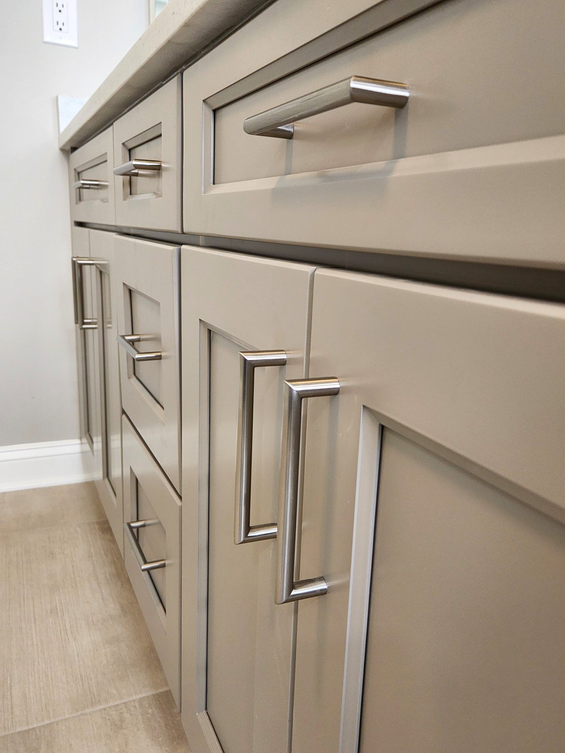 A close up of a kitchen cabinet with stainless steel handles