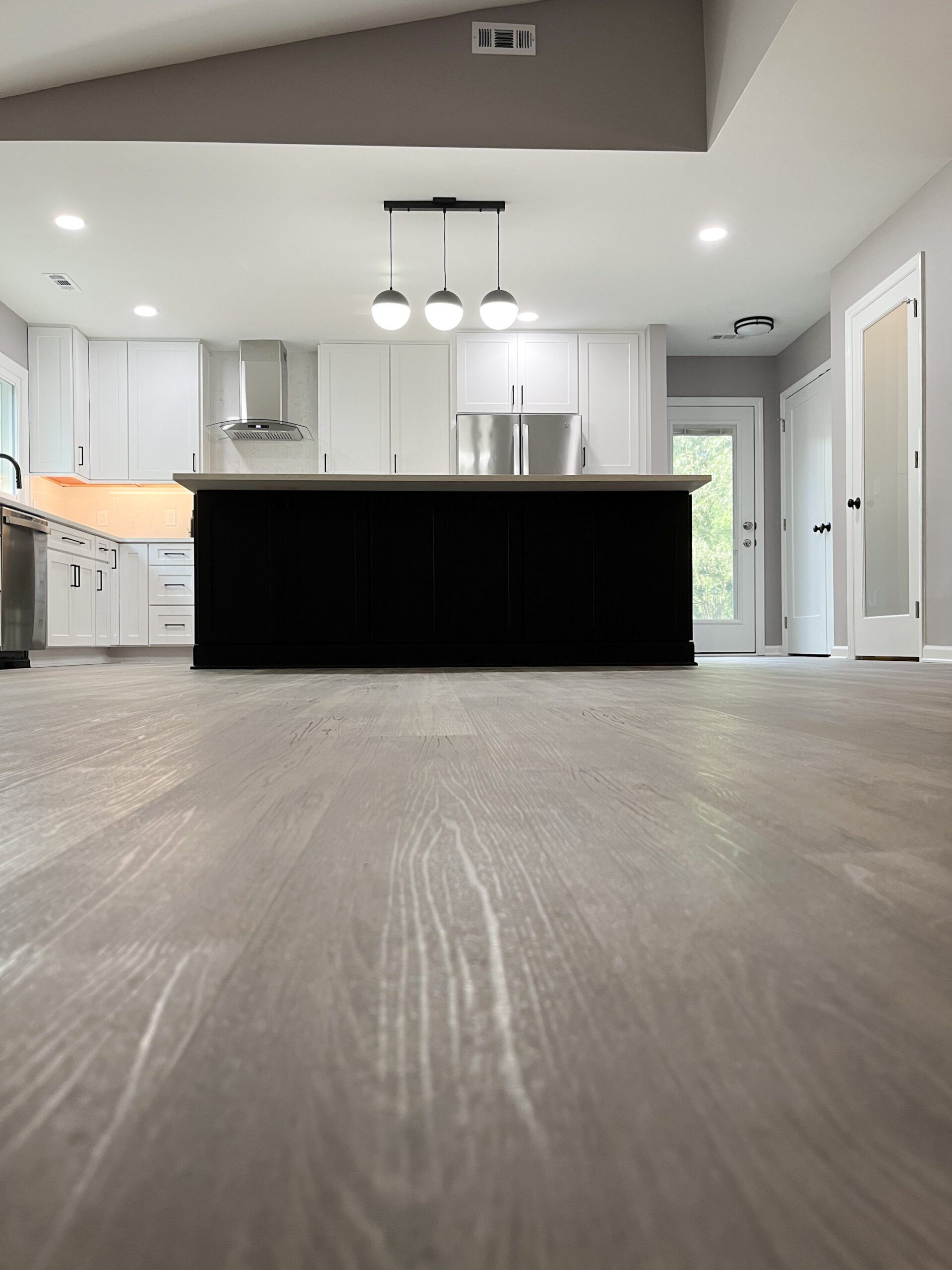 A kitchen with a large island and stainless steel appliances