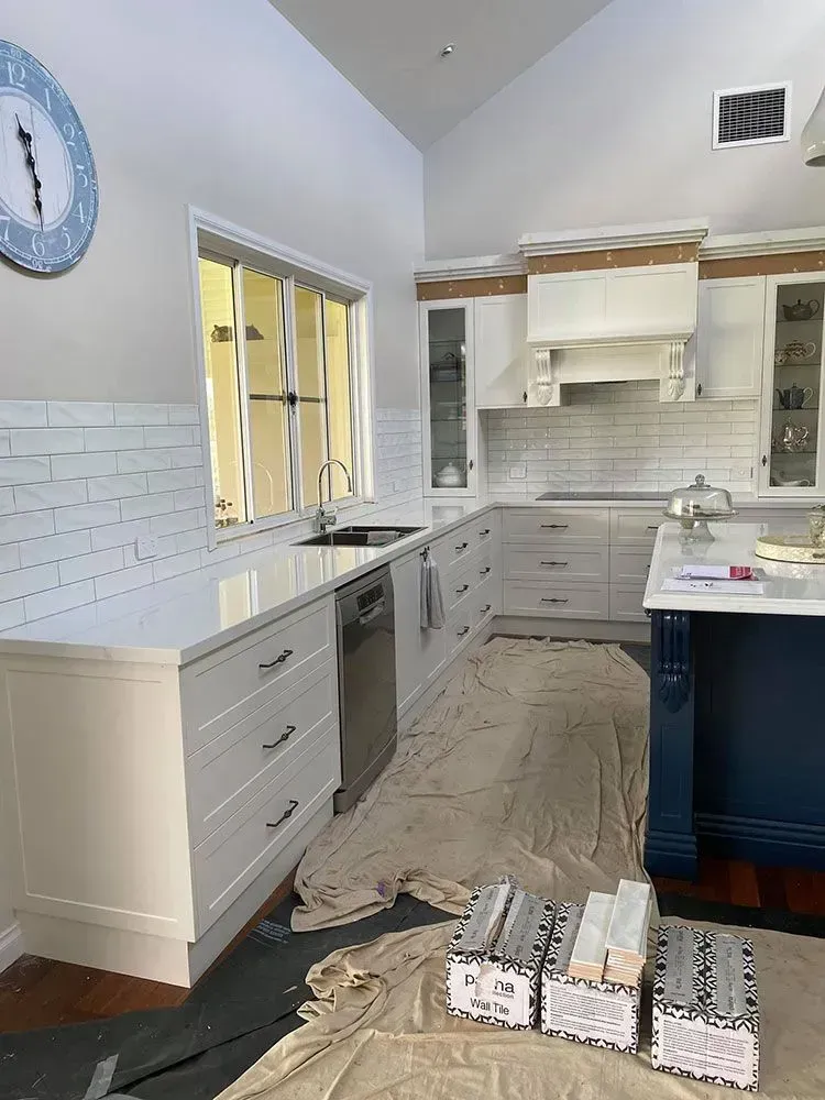 Kitchen Remodel with Light Gray Cabinets, White Backsplash, and Open Boxes on The Floor — Simmonds Kitchens in Walcha, NSW