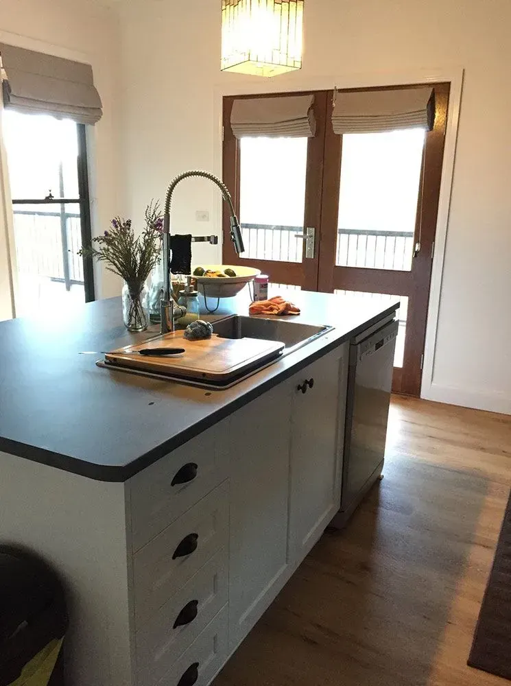 Bright Kitchen with Large Island, Black Countertop, Wood Floors — Simmonds Kitchens in Walcha, NSW