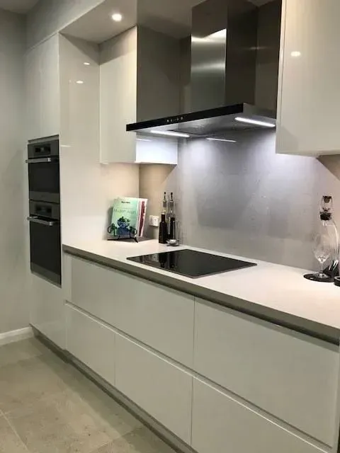 Modern White Kitchen with Built-In Ovens, Black Cooktop, Range Hood — Simmonds Kitchens in Tamworth, NSW