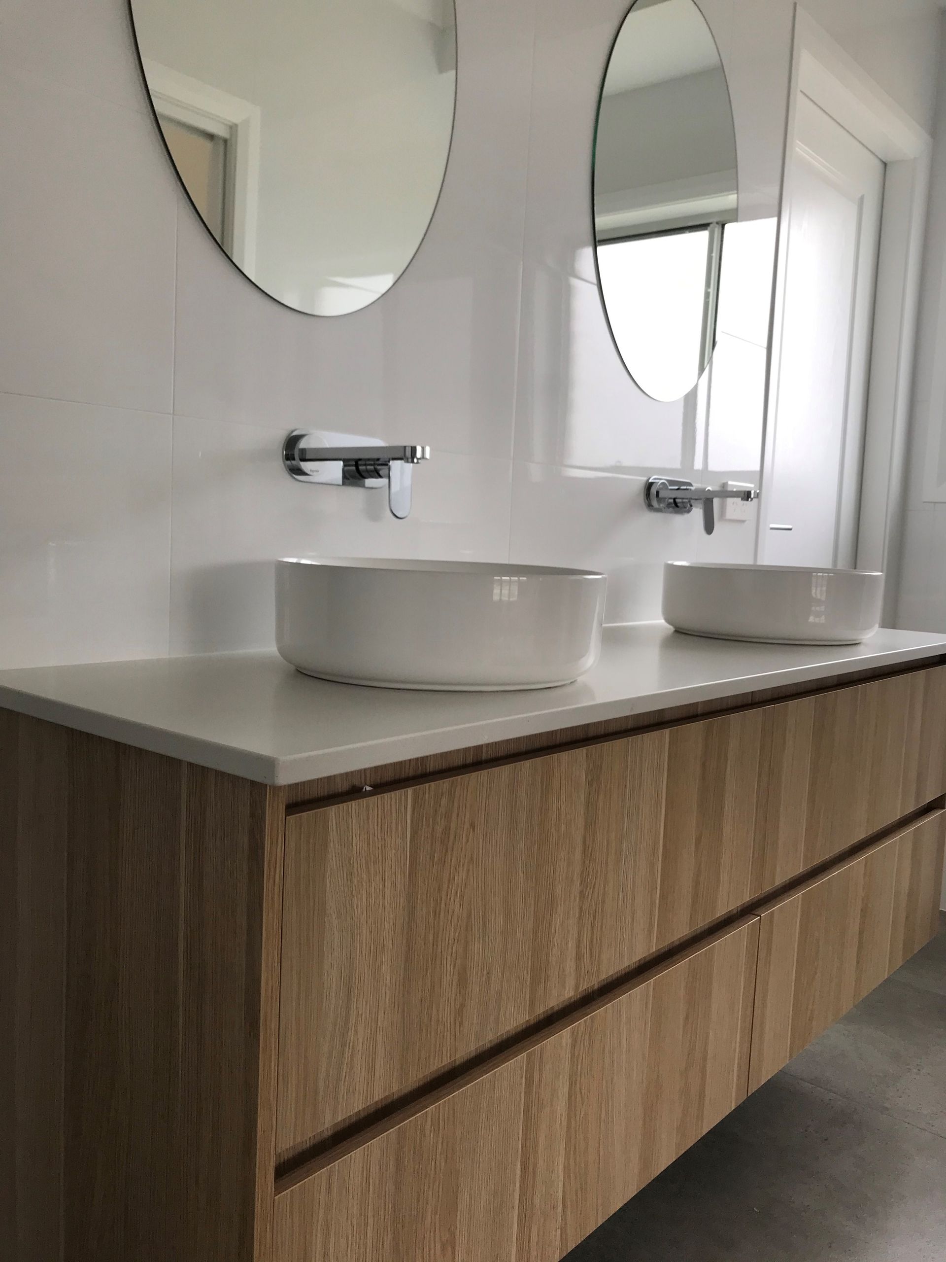 Modern Bathroom Vanity with Two Round Sinks, Chrome Faucets, Mirrors, and Wood Cabinetry — Simmonds Kitchens in Gunnedah, NSW