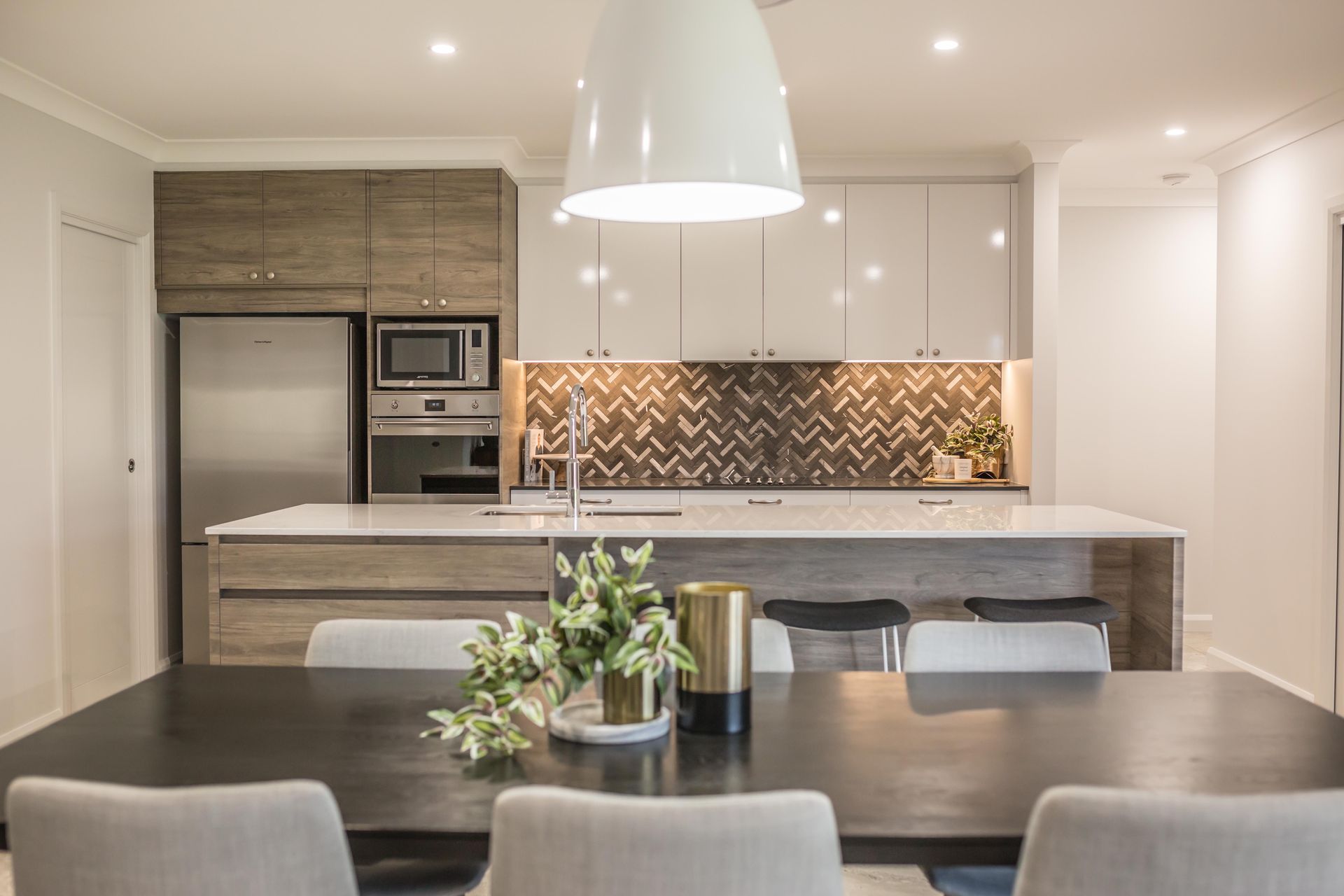 Modern Kitchen and Dining Area with Gray Island, Pendant Light, and Patterned Backsplash — Simmonds Kitchens in Narrabri, NSW