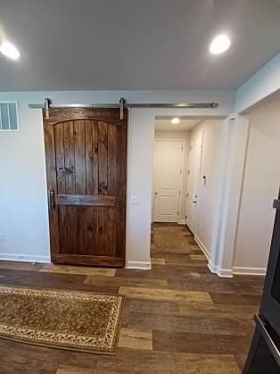 There is a sliding barn door in the middle of the room.