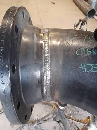 A close up of a metal pipe with a flange on it.