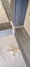 A close up of a metal beam on a concrete floor.
