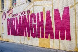 Graffiti mural on a wall reading “BIRMINGHAM” in large pink letters with smaller text above.