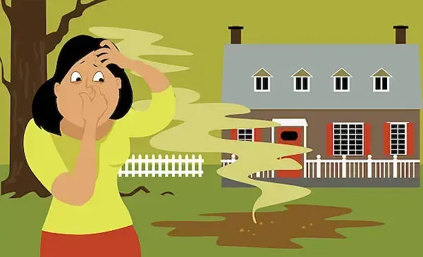 A person holding their nose in disgust while standing near a house with a foul-smelling plume rising from a muddy patch.