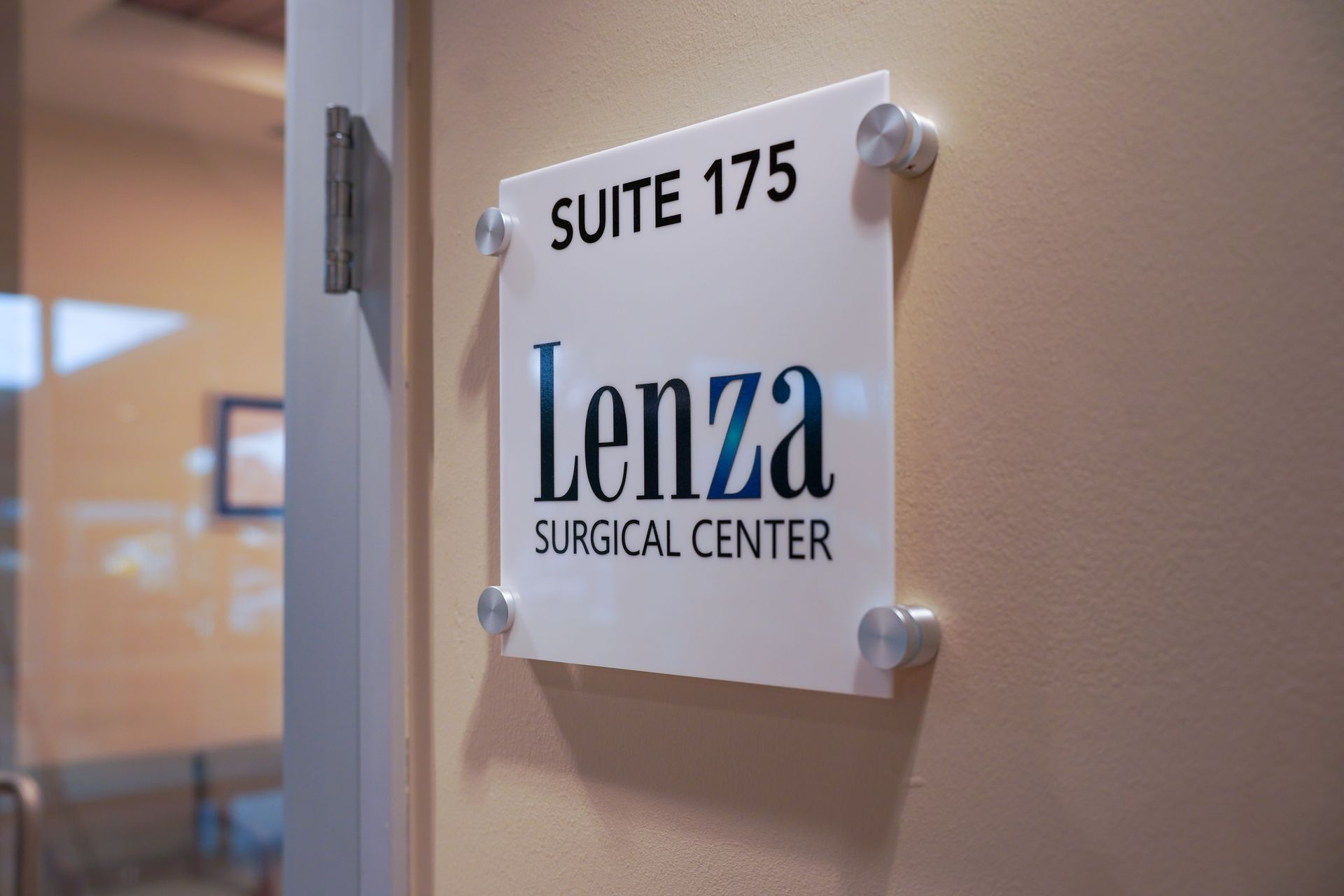 Surgeons in blue scrubs operate on a patient in a sterile operating room.