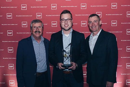 KM Construction receiving the GAF 2019 Triple Excellence Award