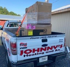 Pickup truck loaded with HVAC equipment, branded 