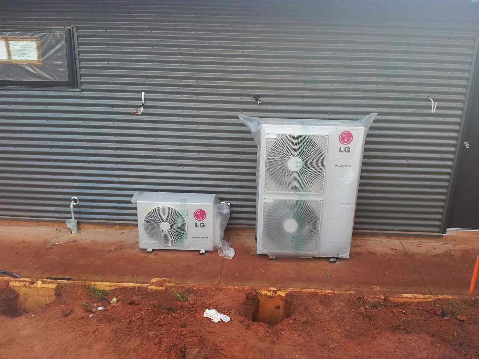 Two Lg Air Conditioners Are Sitting On The Side Of A Building — Climatech In Marcoola, QLD