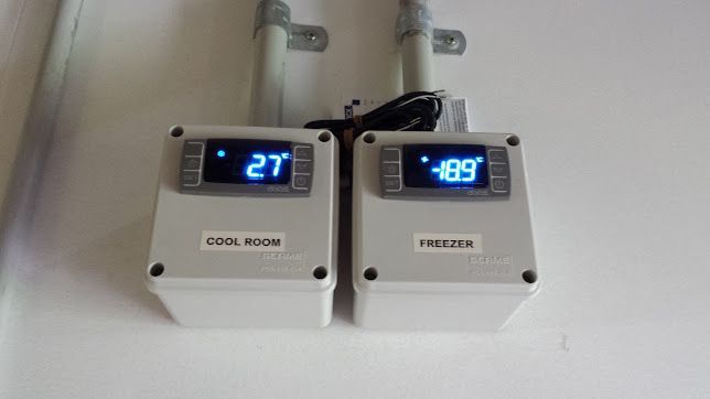 Two Digital Thermostats Are Mounted On A Wall — Climatech In Marcoola, QLD
