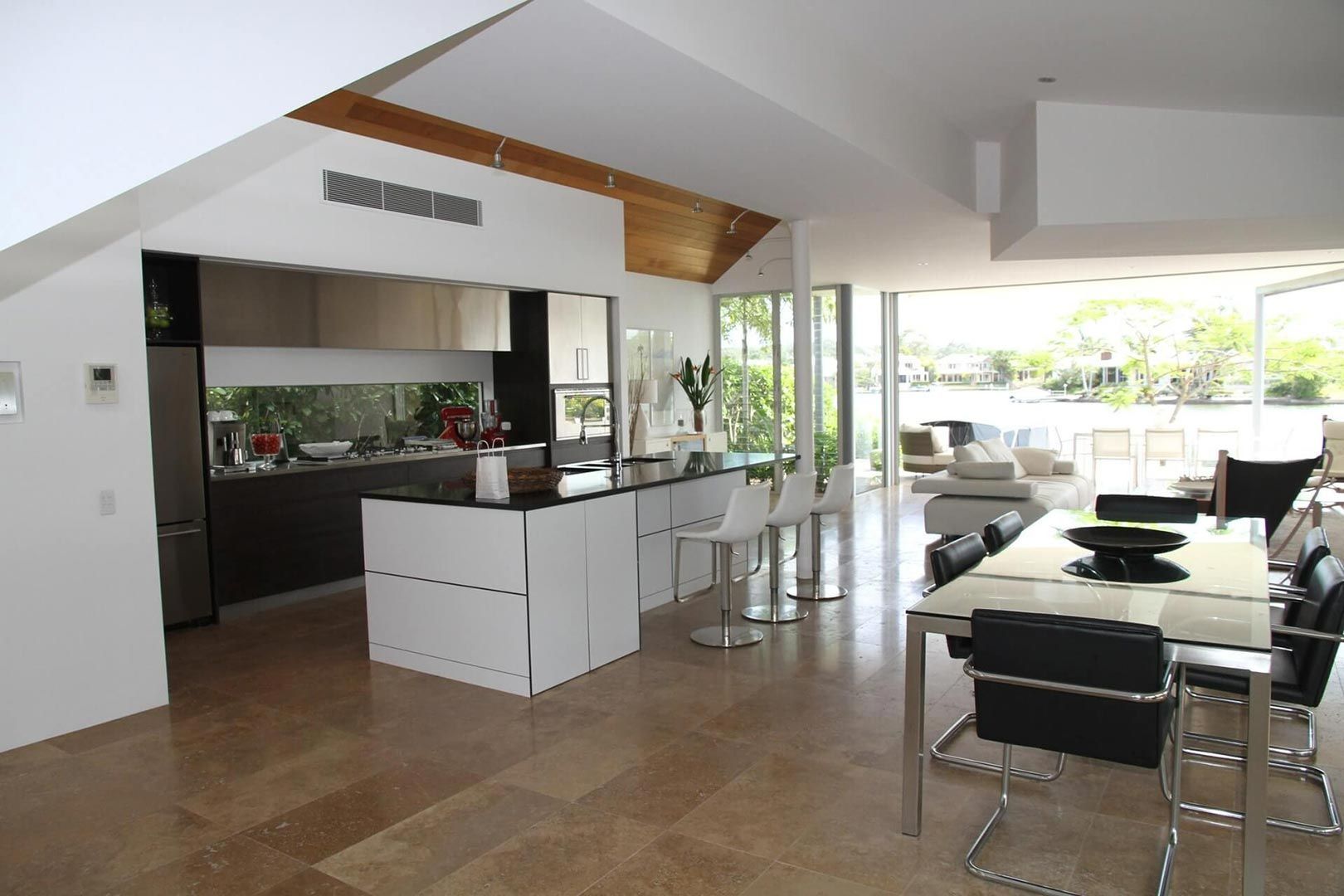 A Kitchen And Dining Room In A House With A Table And Chairs — Climatech In Mooloolaba, QLD